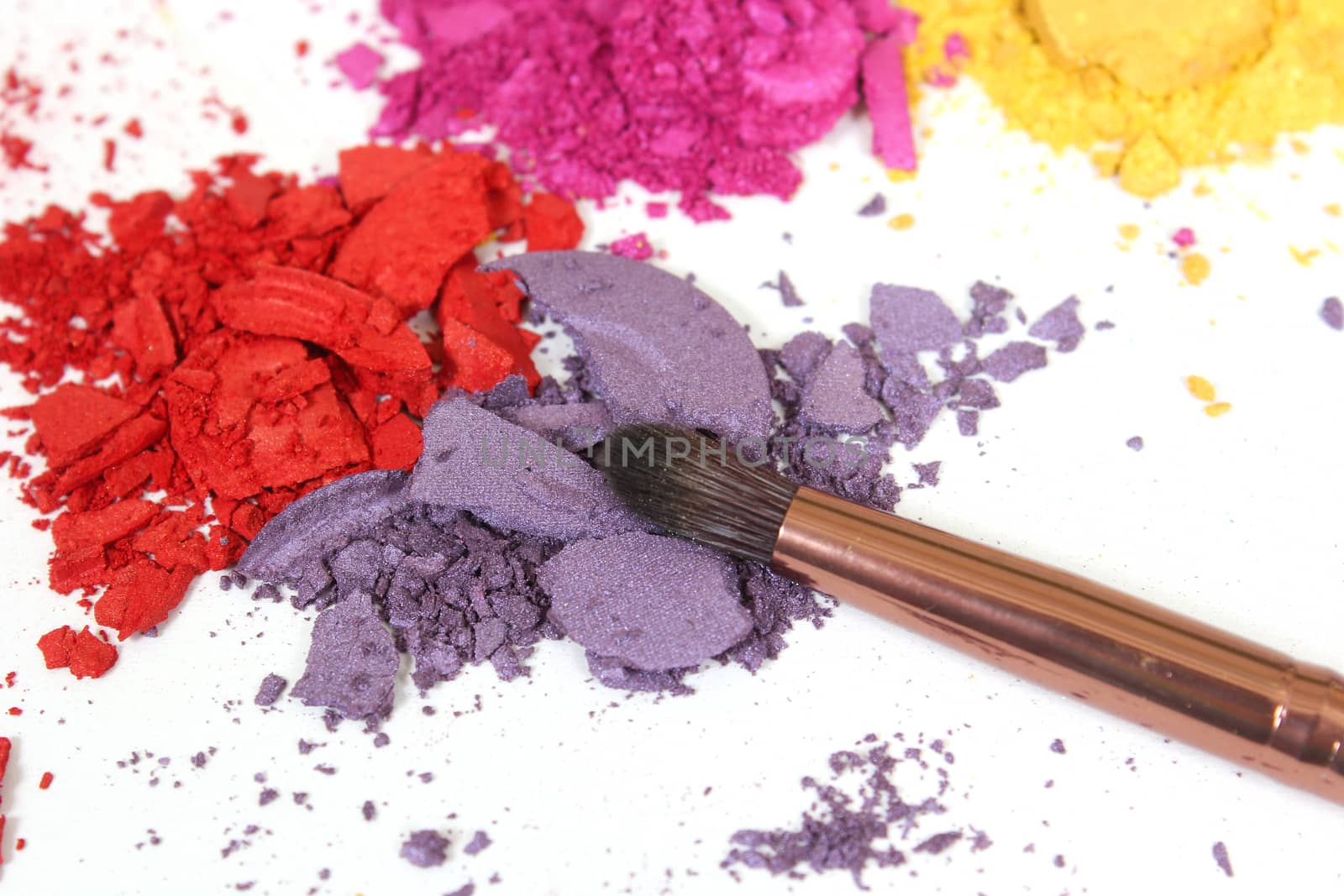 Broken Cosmetic Pigments on White Background