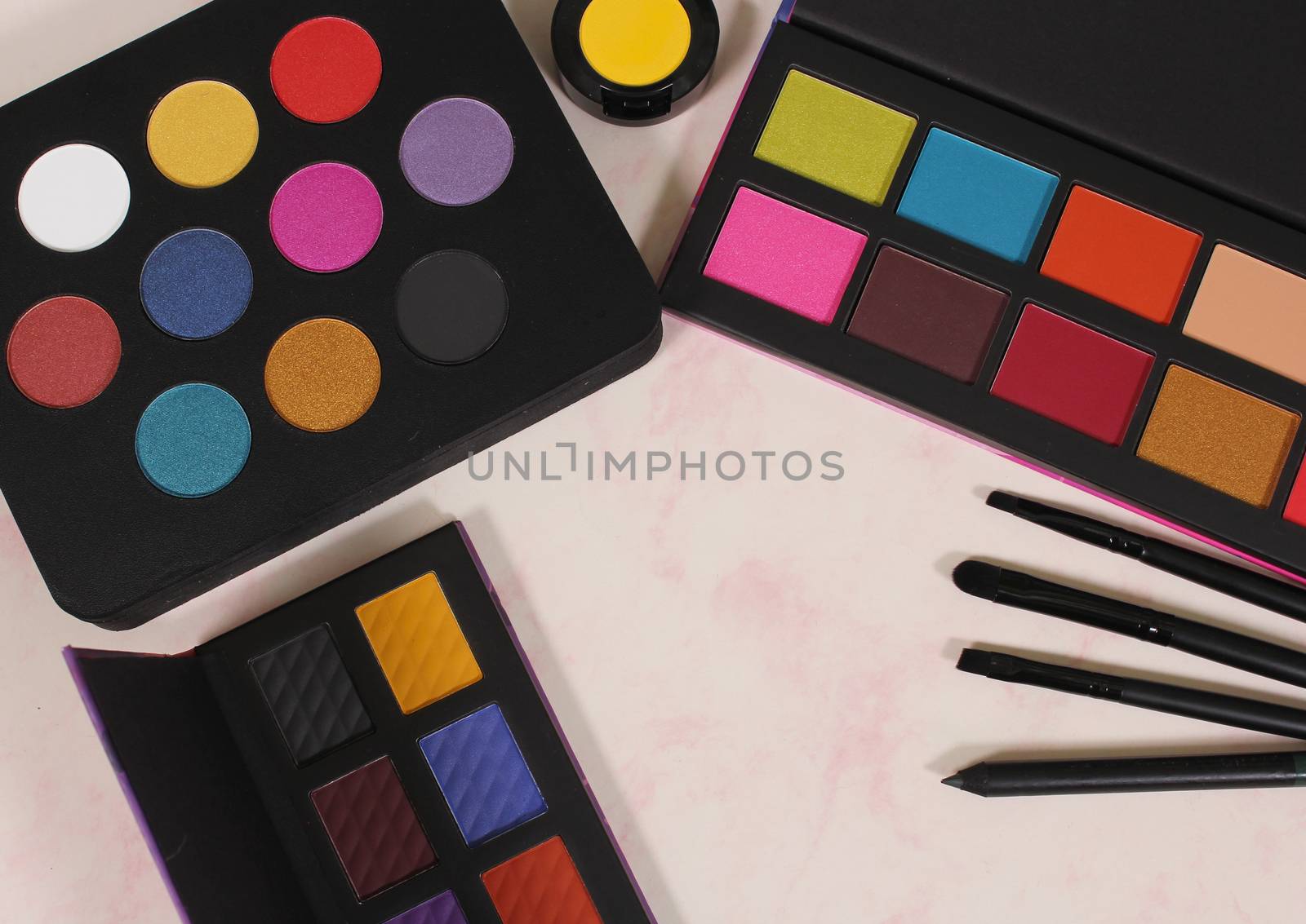 Various Colorful Cosmetics on paper background
