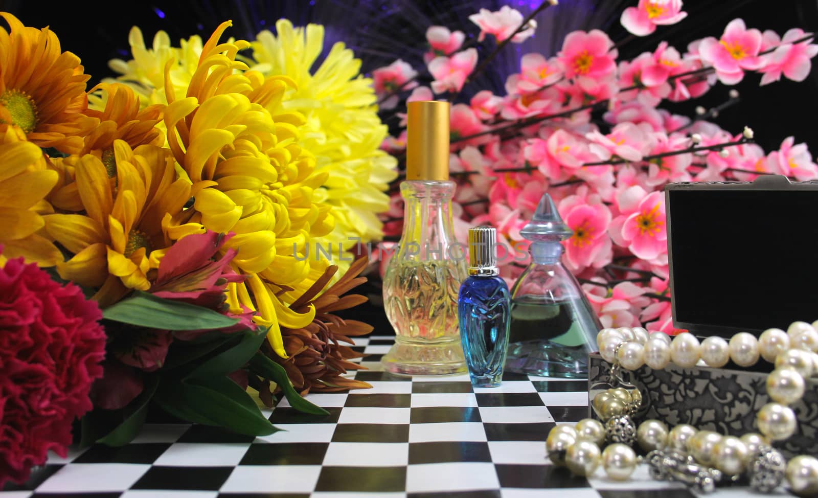 Yellow Flowers With Perfume and Jewelry on Vintage Table