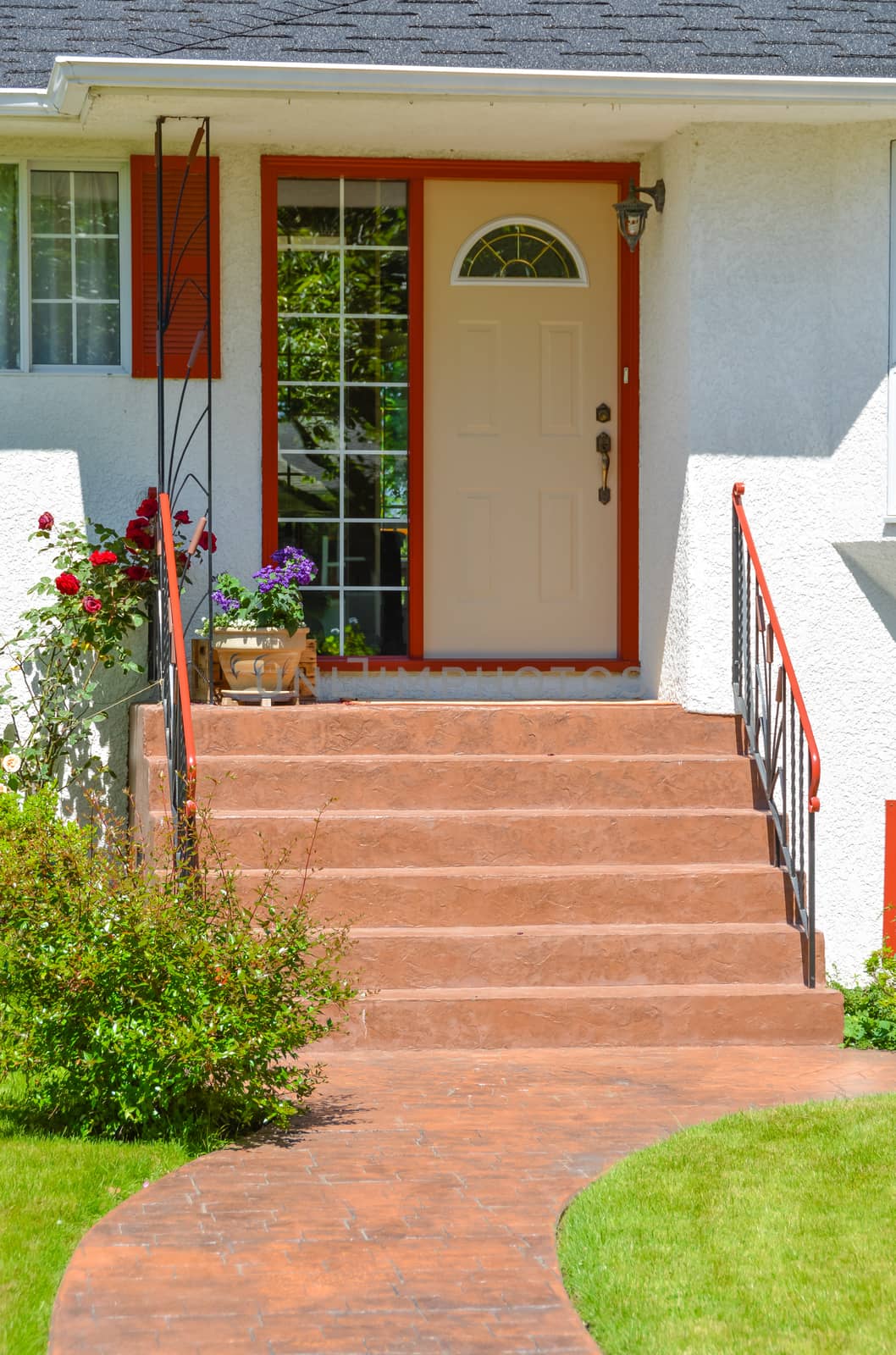 Entrance of family house with doorsteps and pathway in front