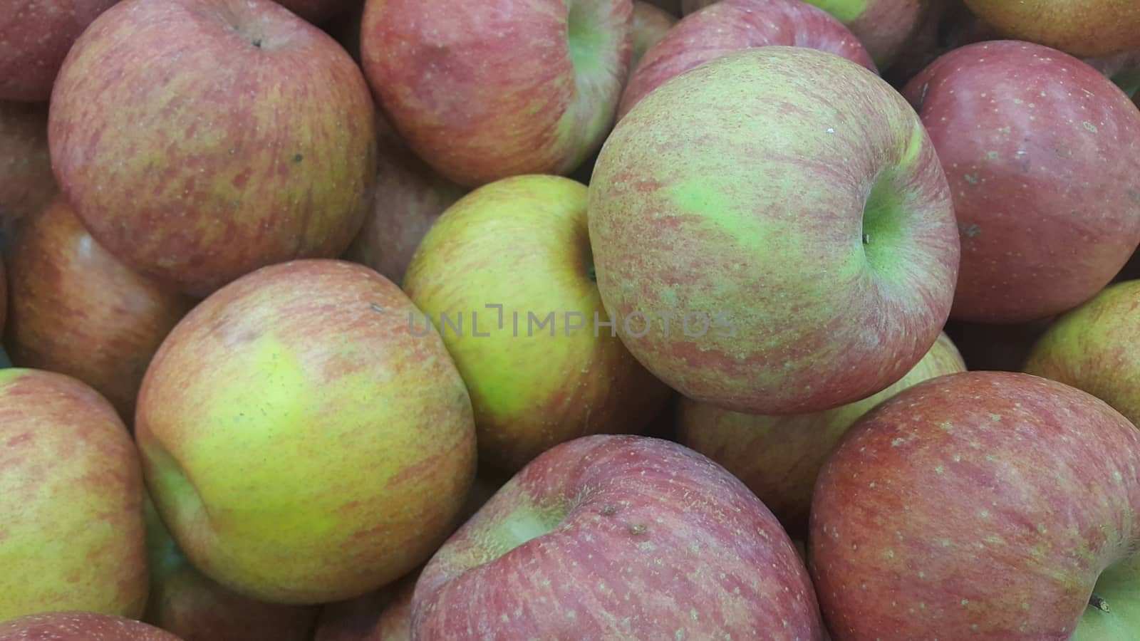 Fresh red and green Apples pile in market for sale. Fruit background for text or messages