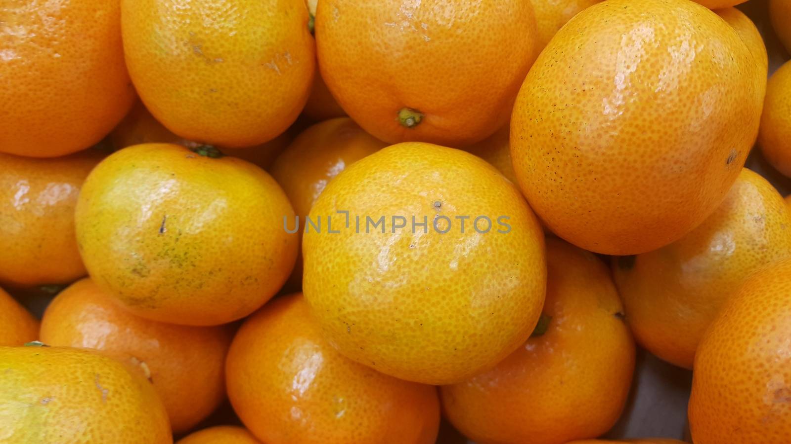 Fresh oranges in supermarket for sale, pile of orange in market for texture