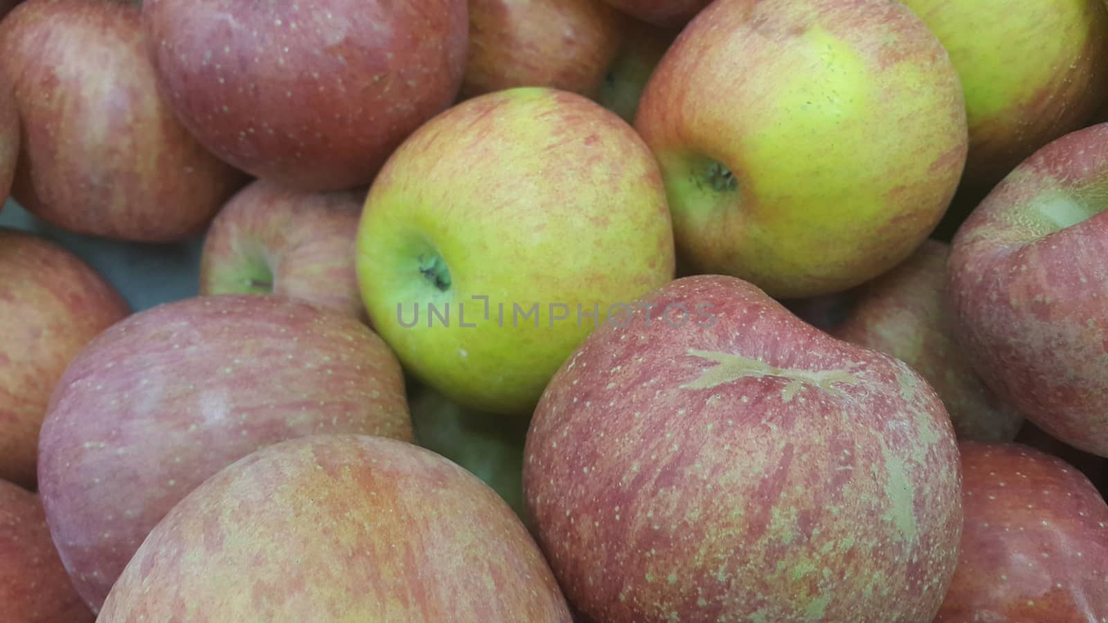 Fresh red and green Apples pile in market for sale. Fruit background for text or messages