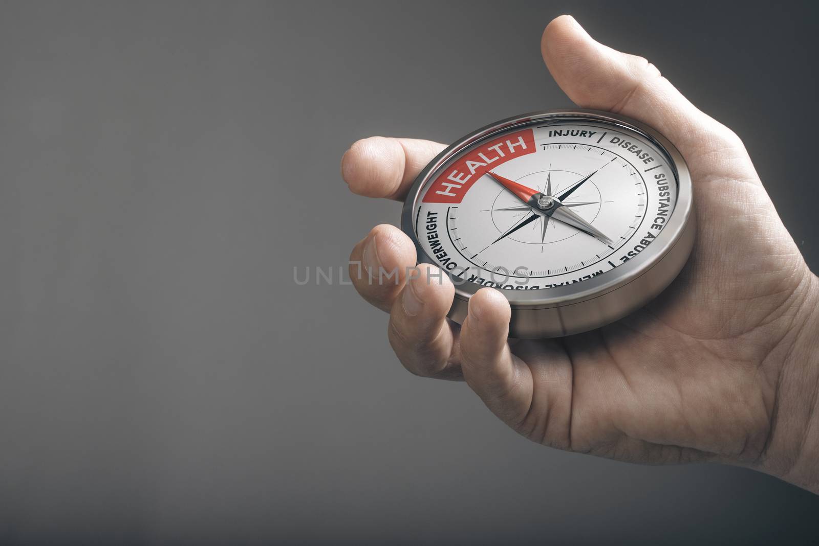 Hand holding a compass with needle pointing the word health. Healthcare concept. Composite image between a hand photography and a 3D object.