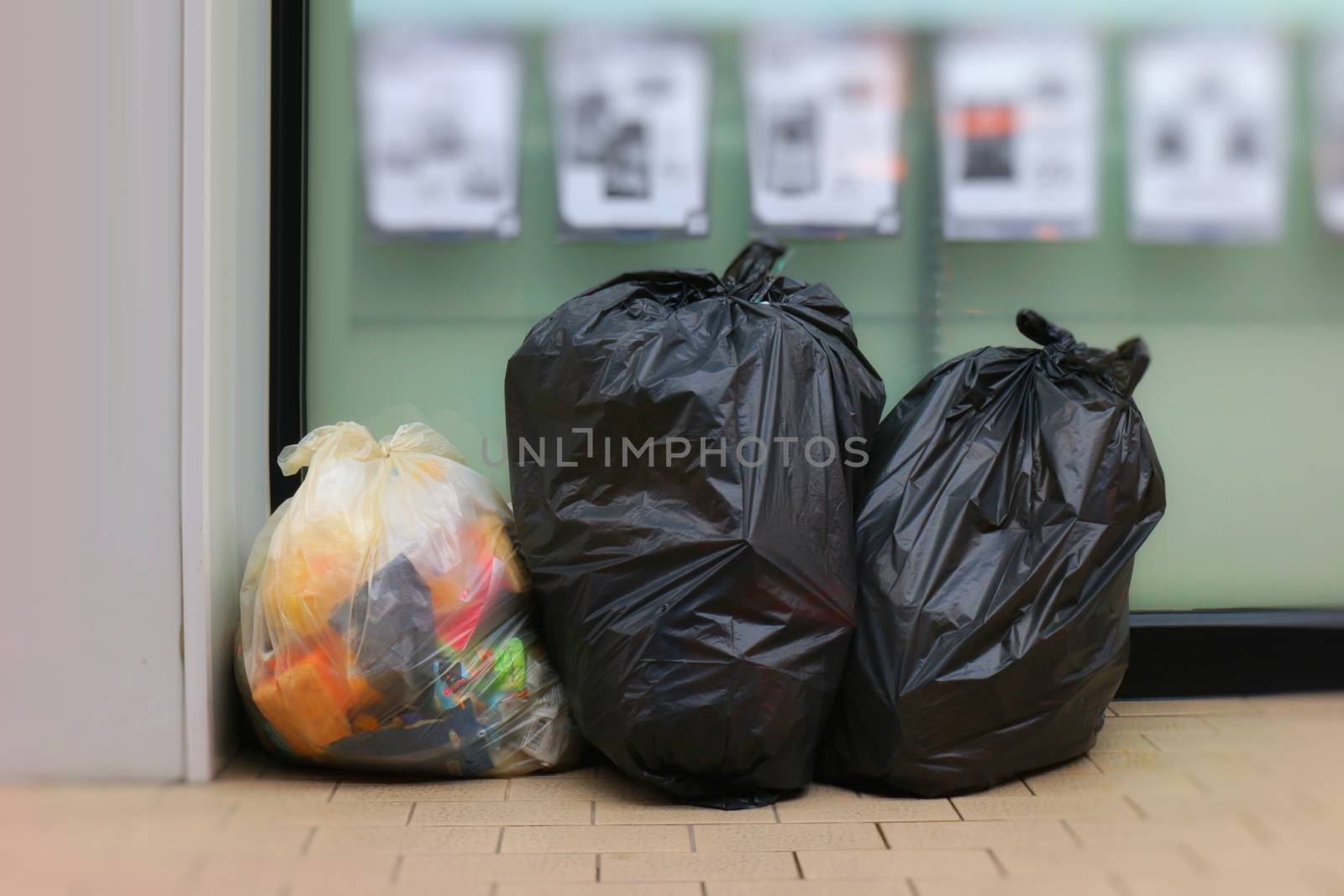 Three Trash Bags, Garbage bag black placed front convenience store, Bin, Trash, trash bag, trash on sidewalk, Three bags bin of garbage bags on the floor, Piles of garbage, piles of black garbage bags