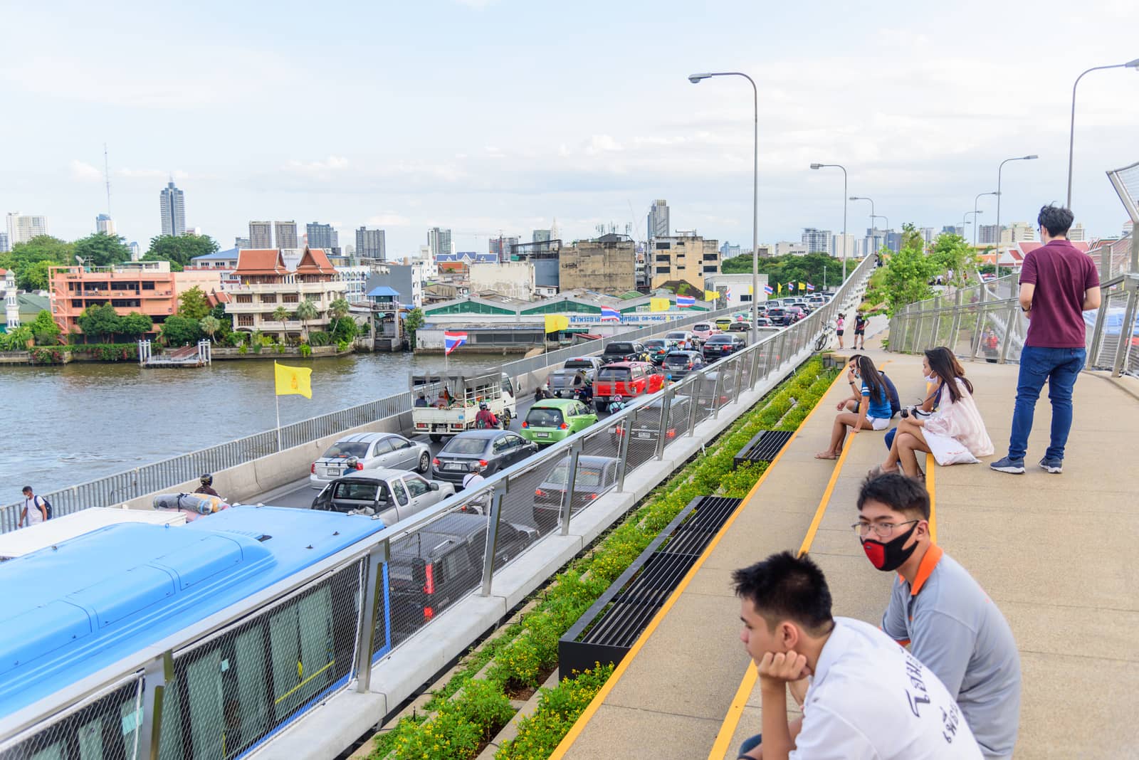 Bangkok , Thailand - 1 July, 2020: People walking and sitting in relax at Chao Phraya Sky Park  landmark in Bangkok