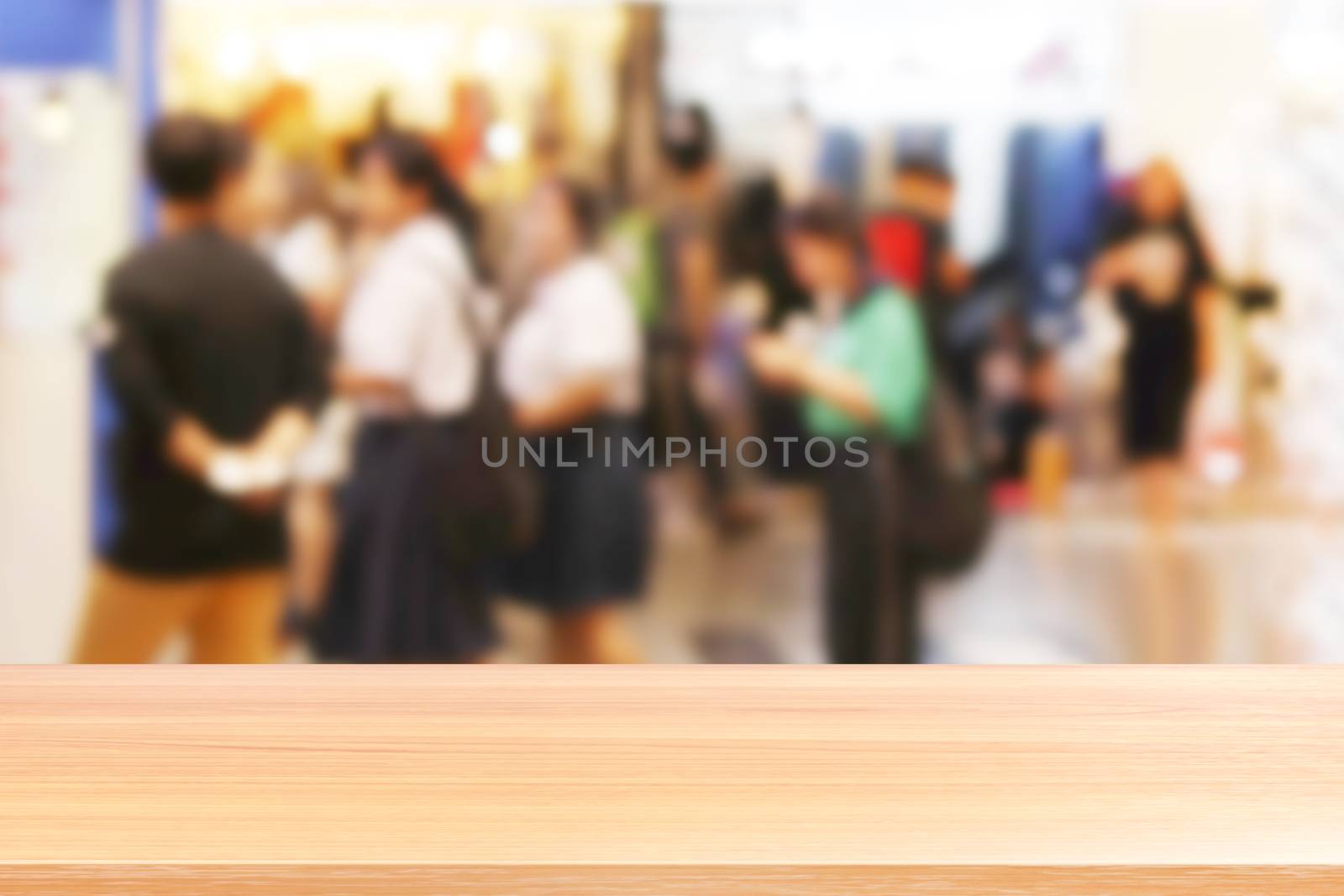 wood plank on blurred inside shopping mall and people walking shop, wood table board empty on clothing store fashion blur inside mall soft background