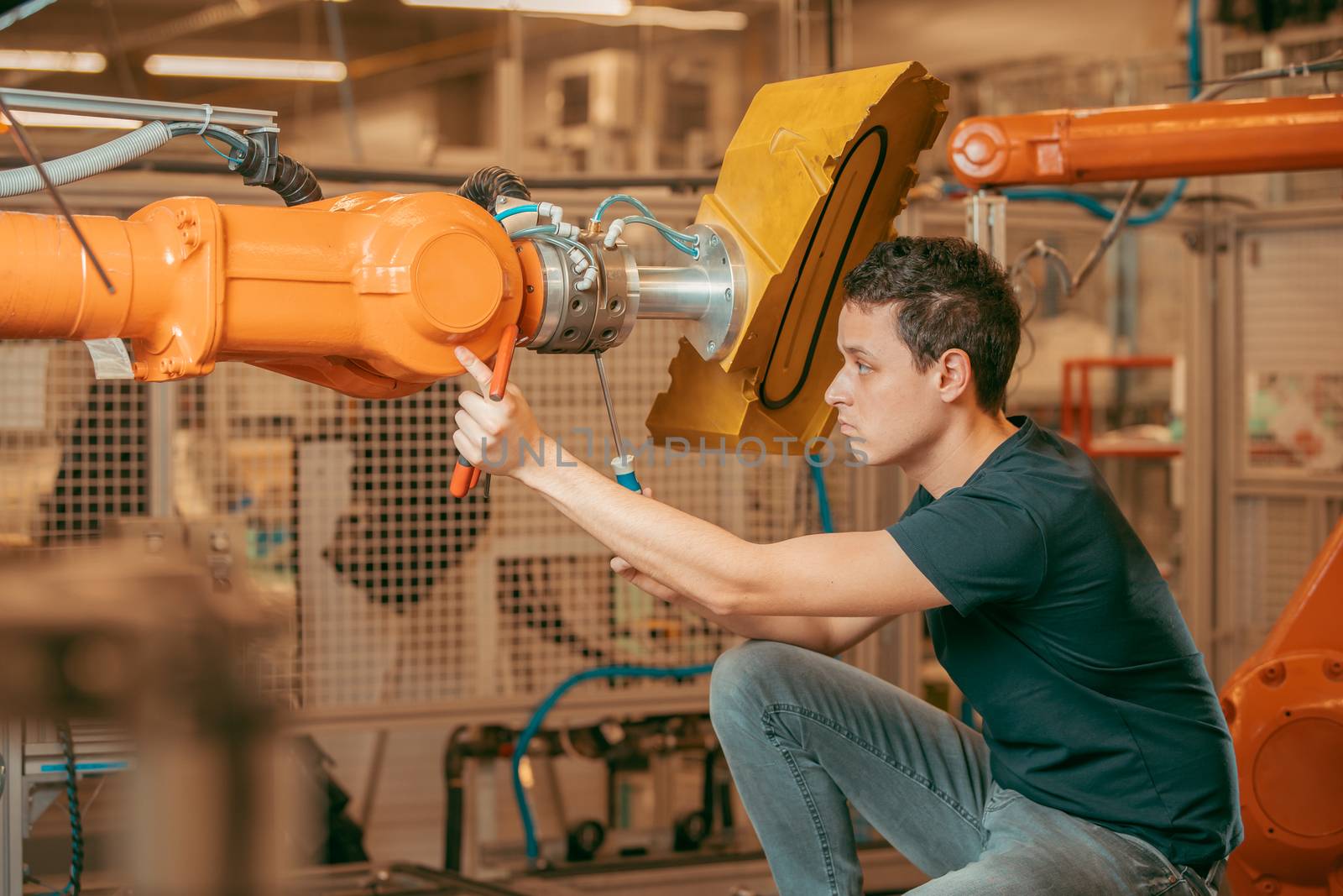 setting up a robotic line with automatic arms before starting the process.