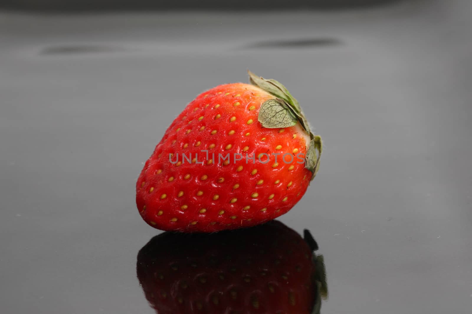 Strawberry in black background by piyato