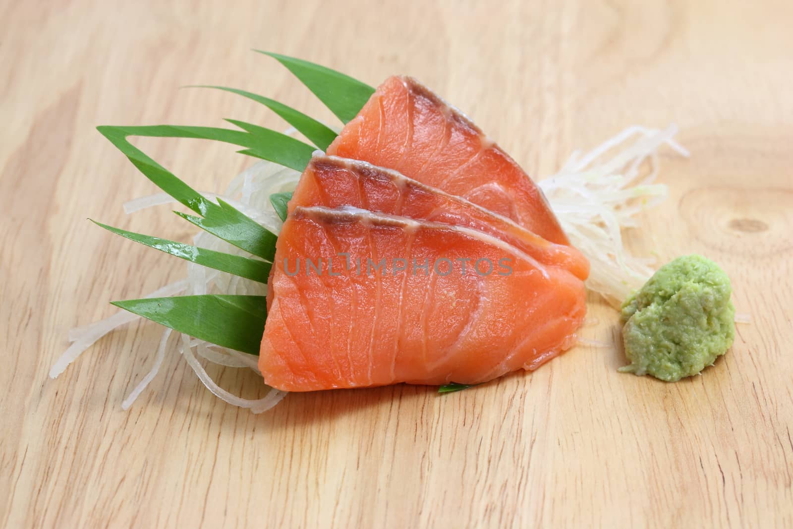 salmon sashimi in wood background by piyato