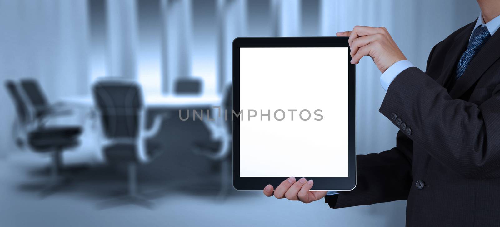 businessman success working with blank tablet computer his board room background