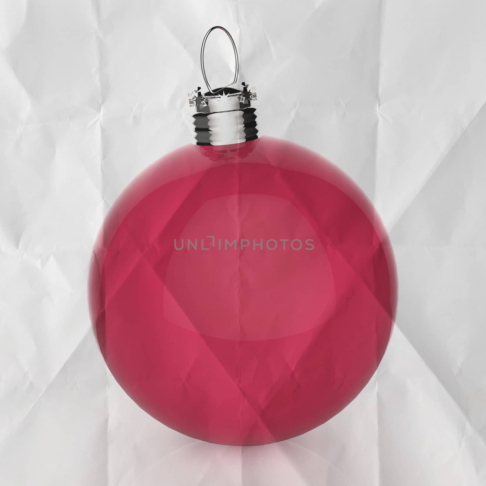 Empty Christmas ball ornament on crumpled paper background