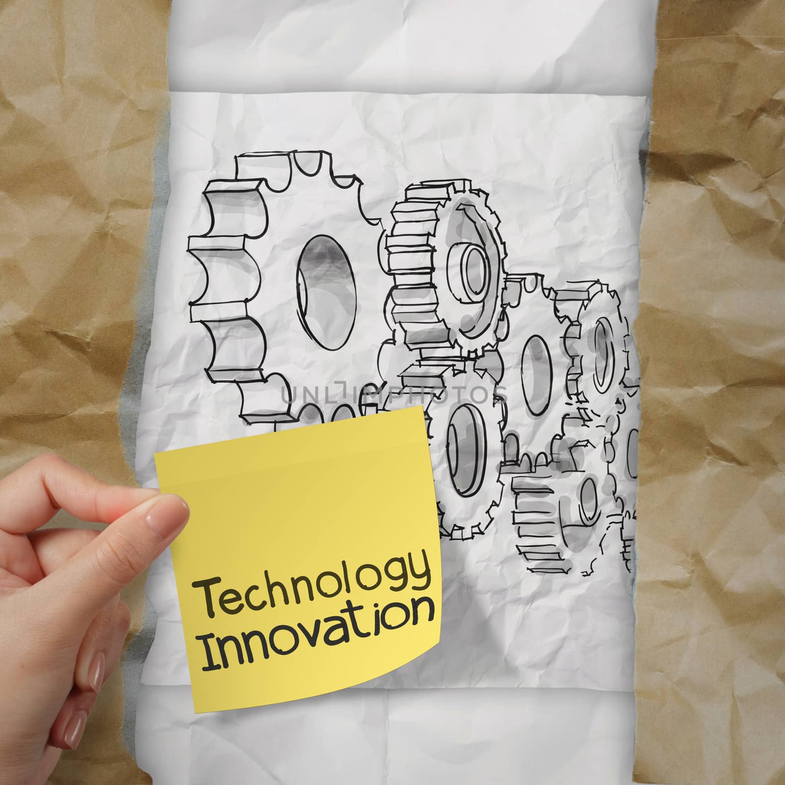 hand holding innovation on sticky note with gear to success concept on crumpled paper 