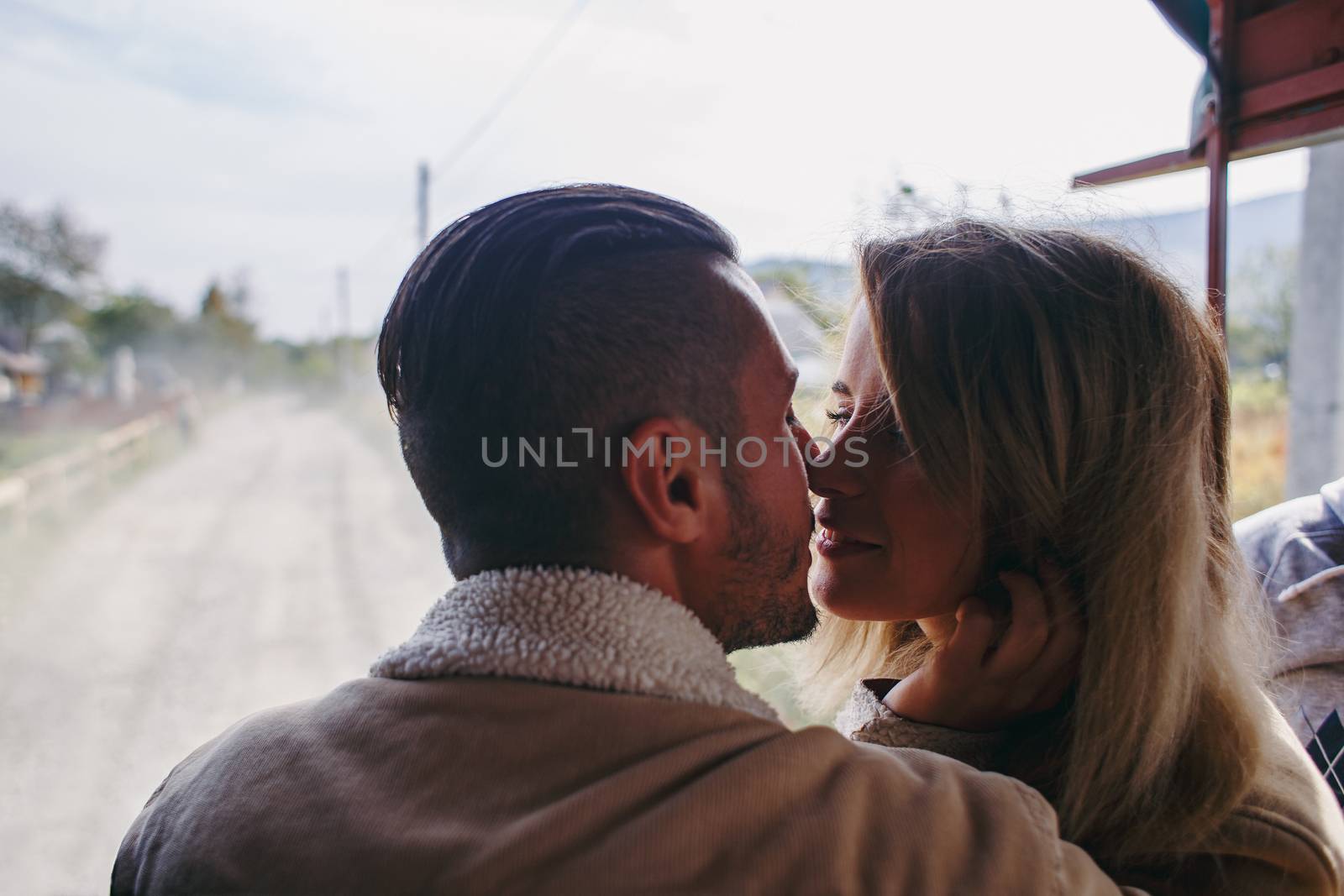 A beautiful girl and a handsome man in military truck. Lovestory. Military vehicle. Military fashion.Carpathian mountains.