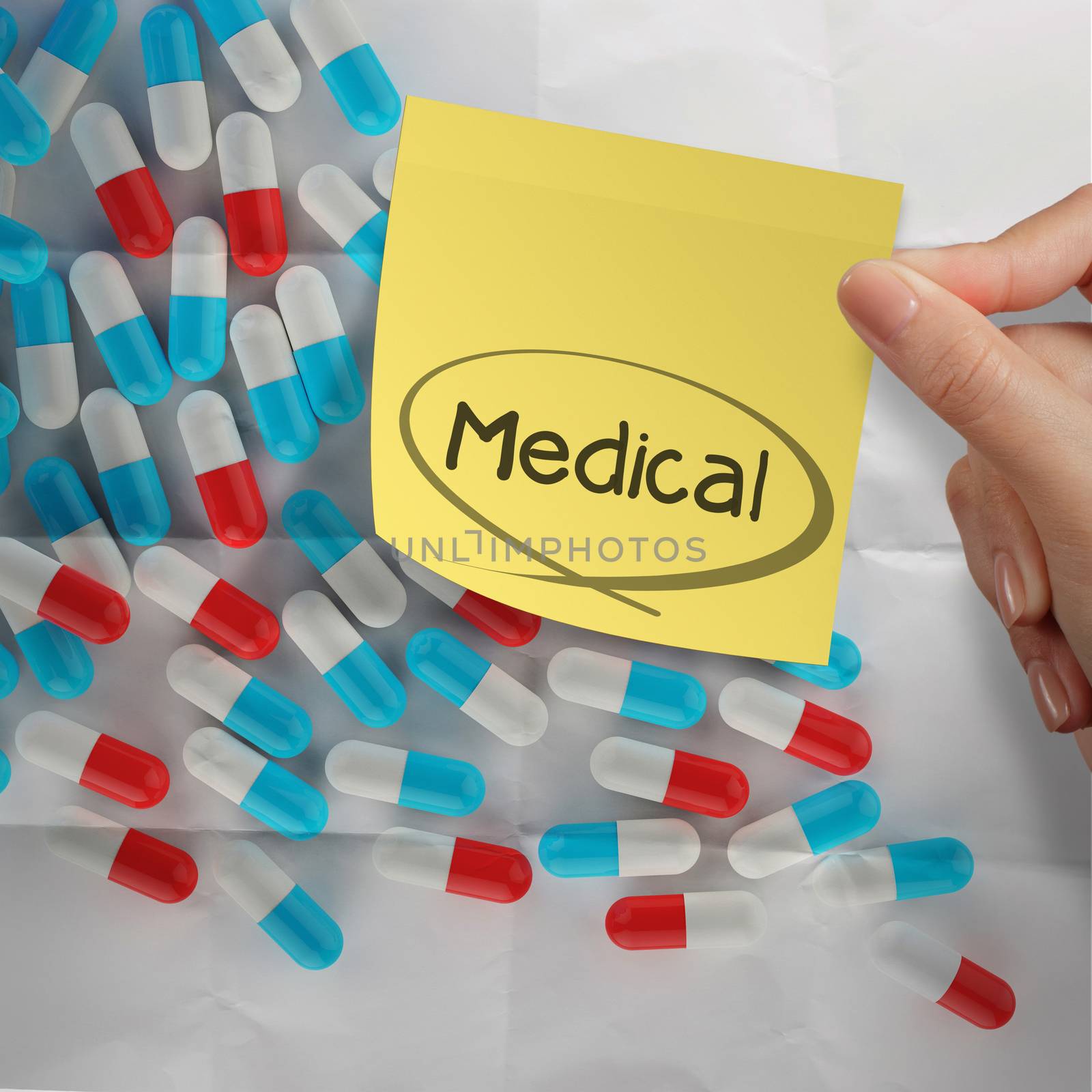 hand holding sticky note medical with Pills spilling on crumpled paper background as concept