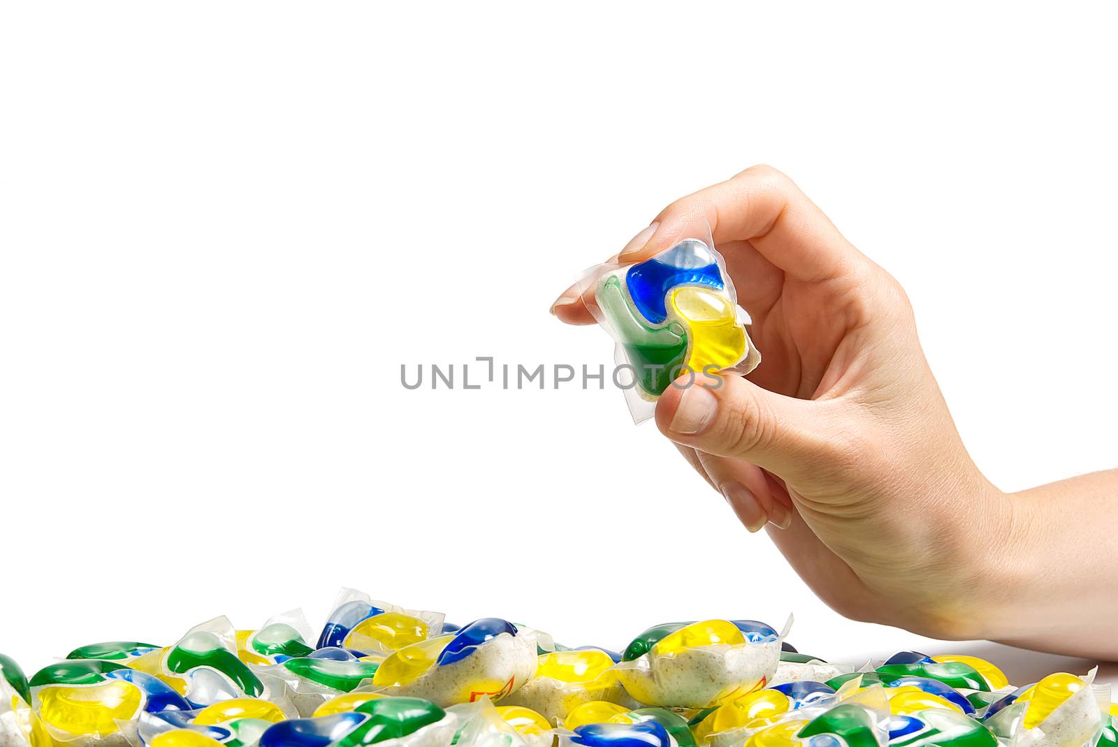 hand holds the Dishwasher Capsule on white background. copy space