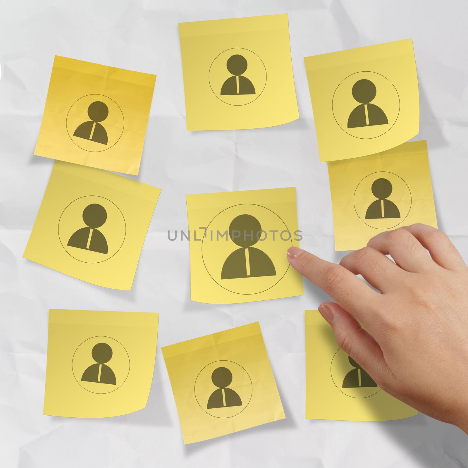 hand choosing people icon on sticky note with crumpled paper as human resources concept