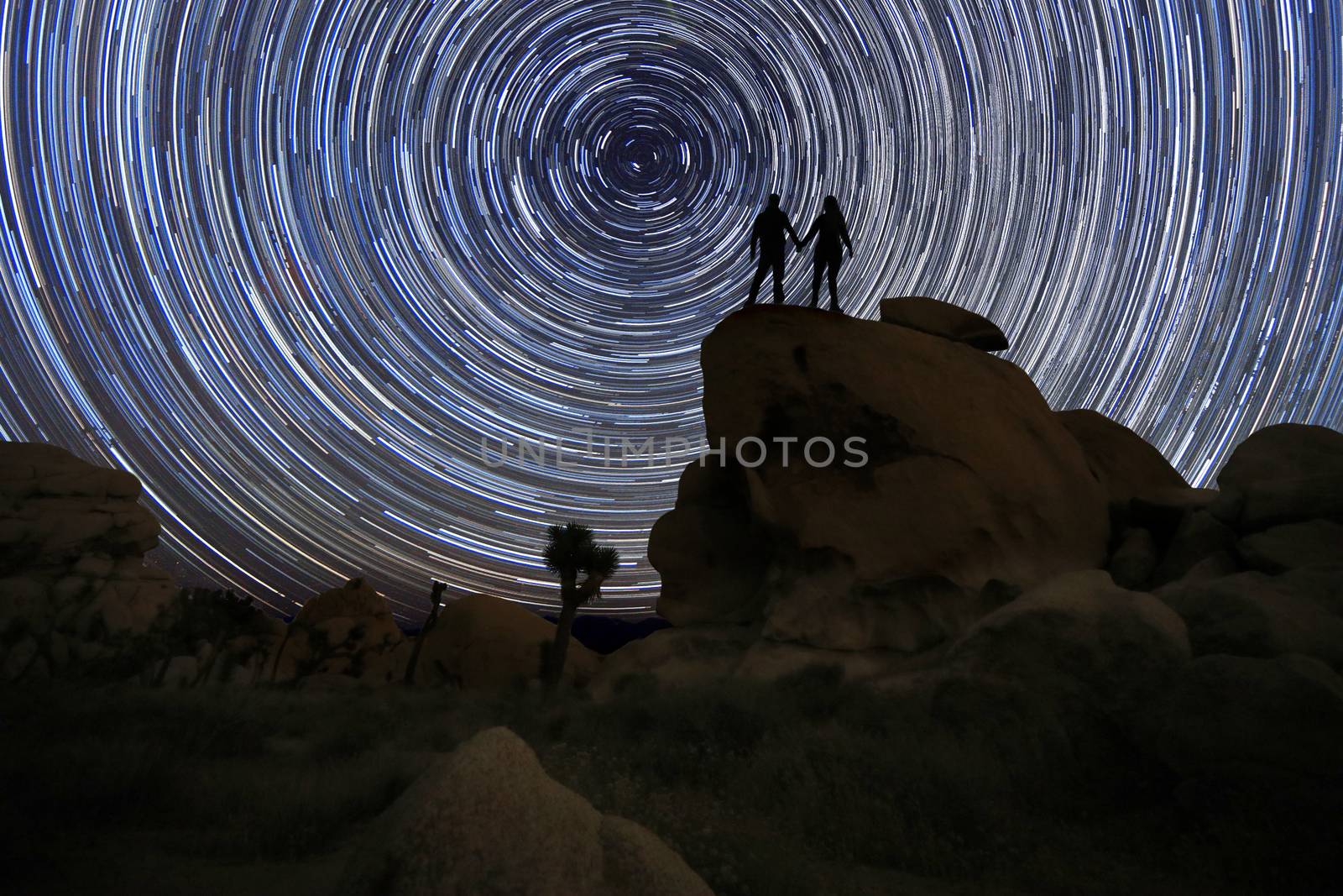 Happy Couple Silhouette Under the Stars at Night