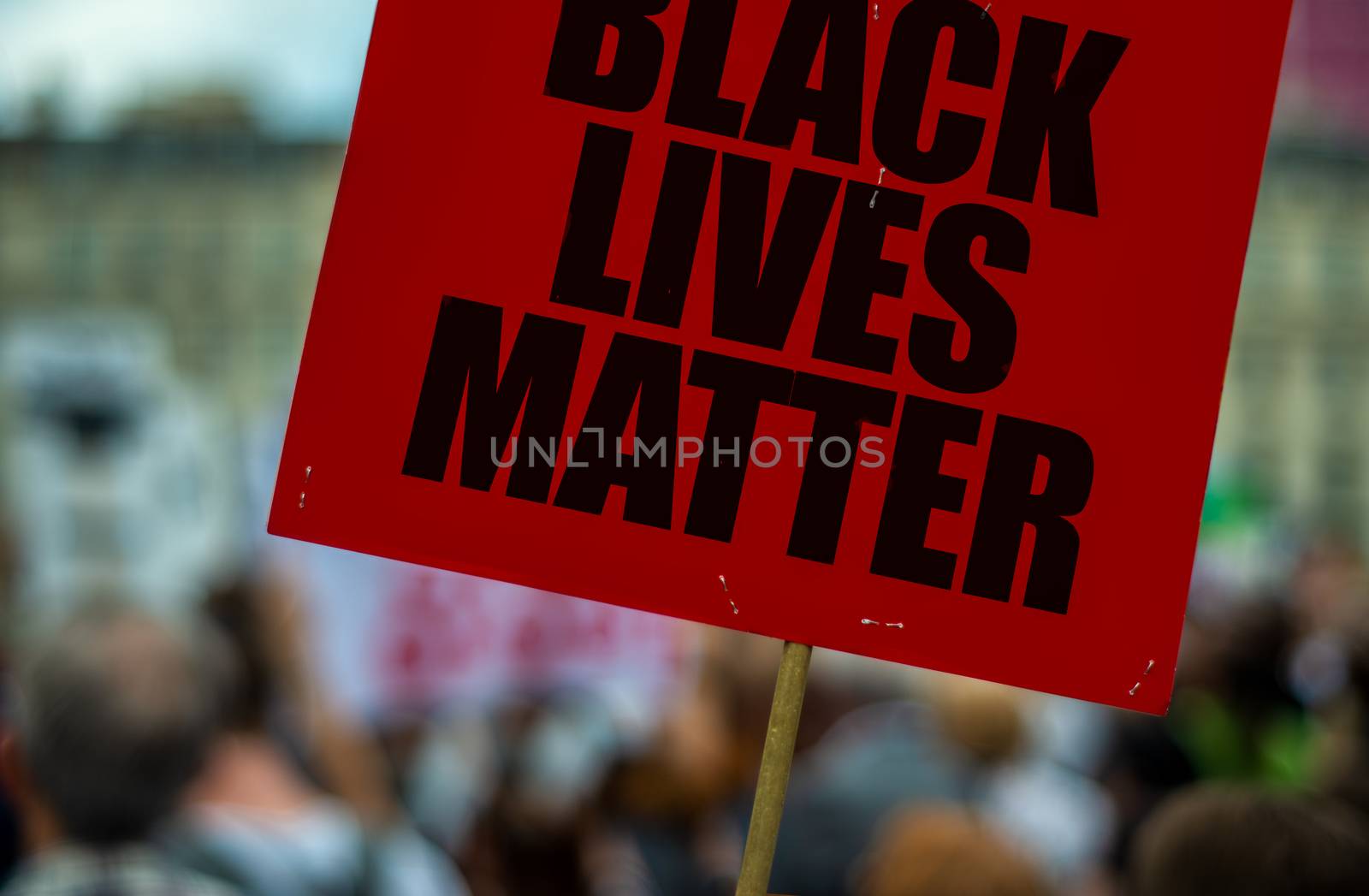 A Black Lives Matter Sign Or Placard At A Busy Street March Protesting Racial Injustice
