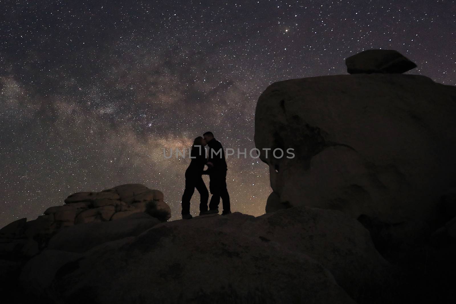 Loving Couple Silhouette Under the Stars at Night by tobkatrina