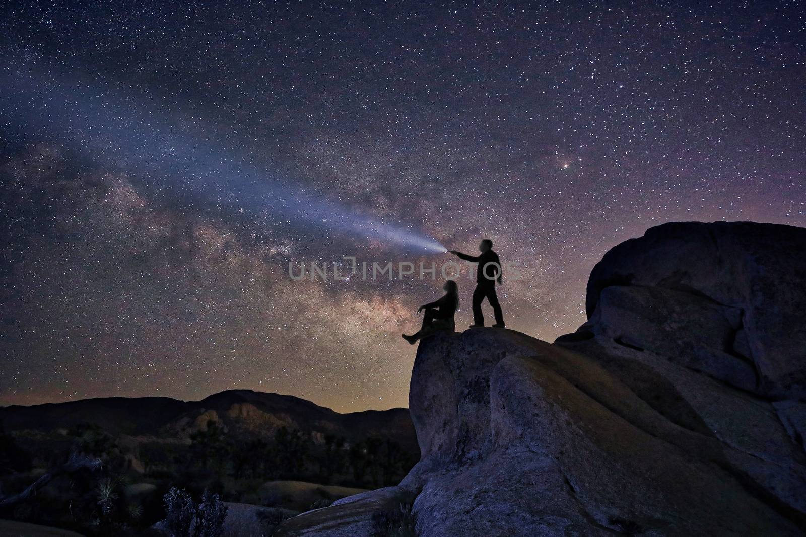 Happy Couple Silhouette Under the Stars at Night