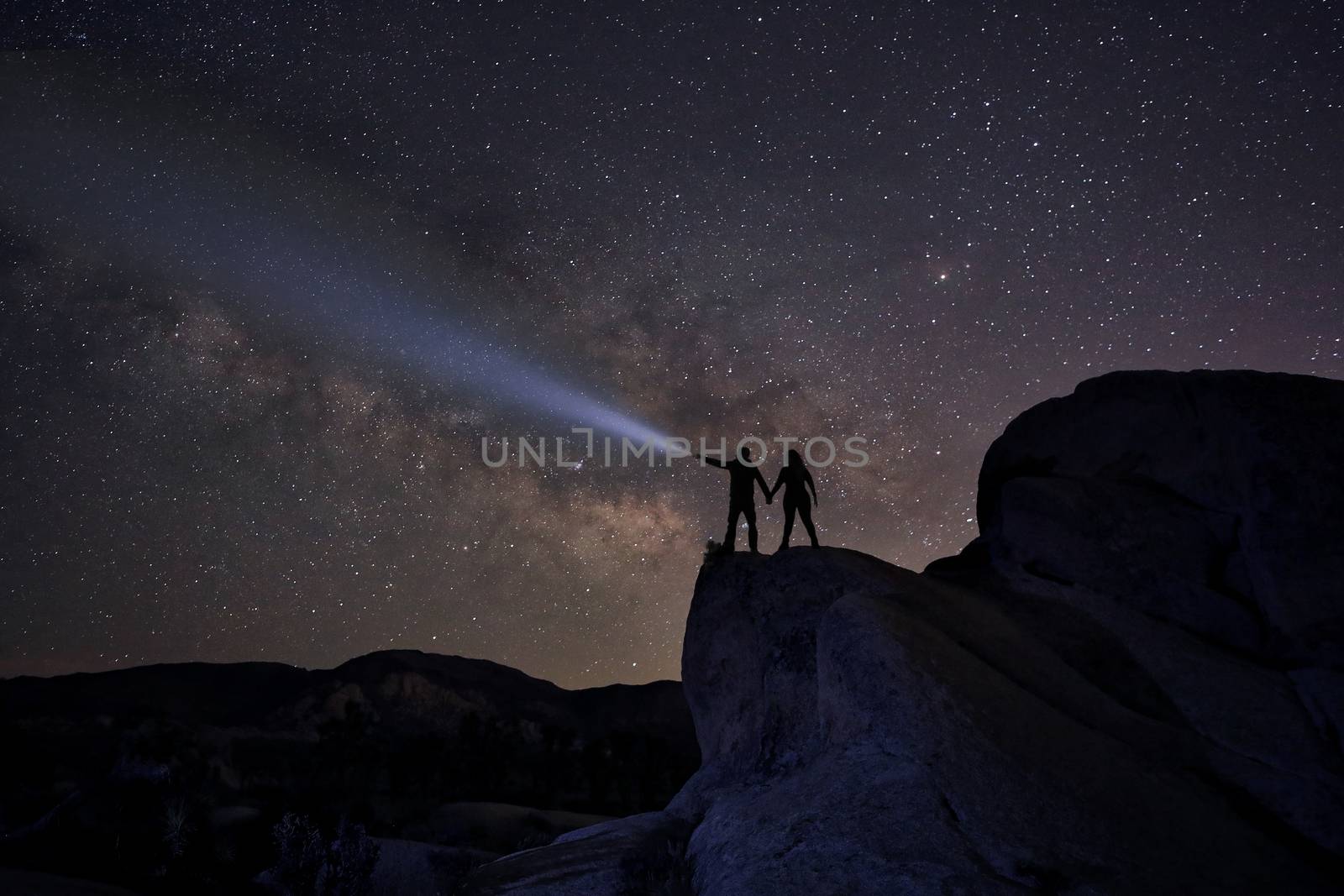 Happy Couple Silhouette Under the Stars at Night