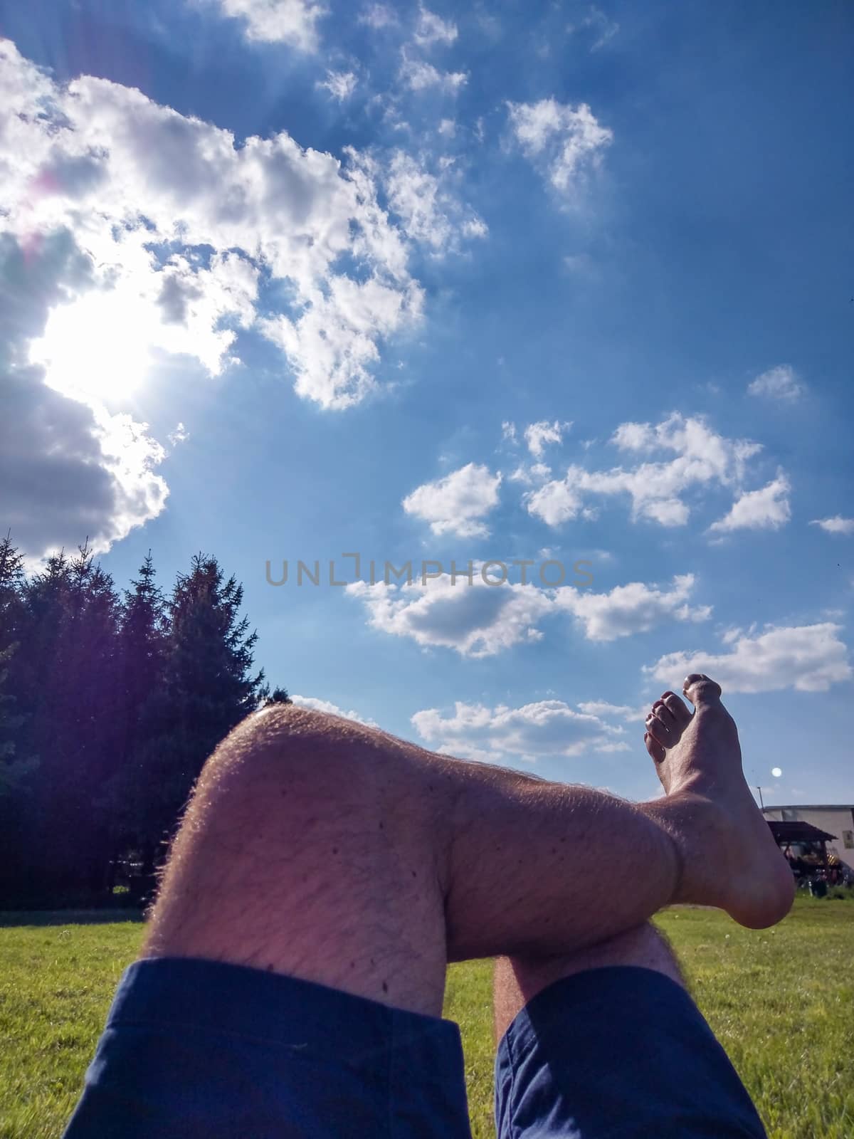 Feet of a man relaxing in shorts during a sunny day