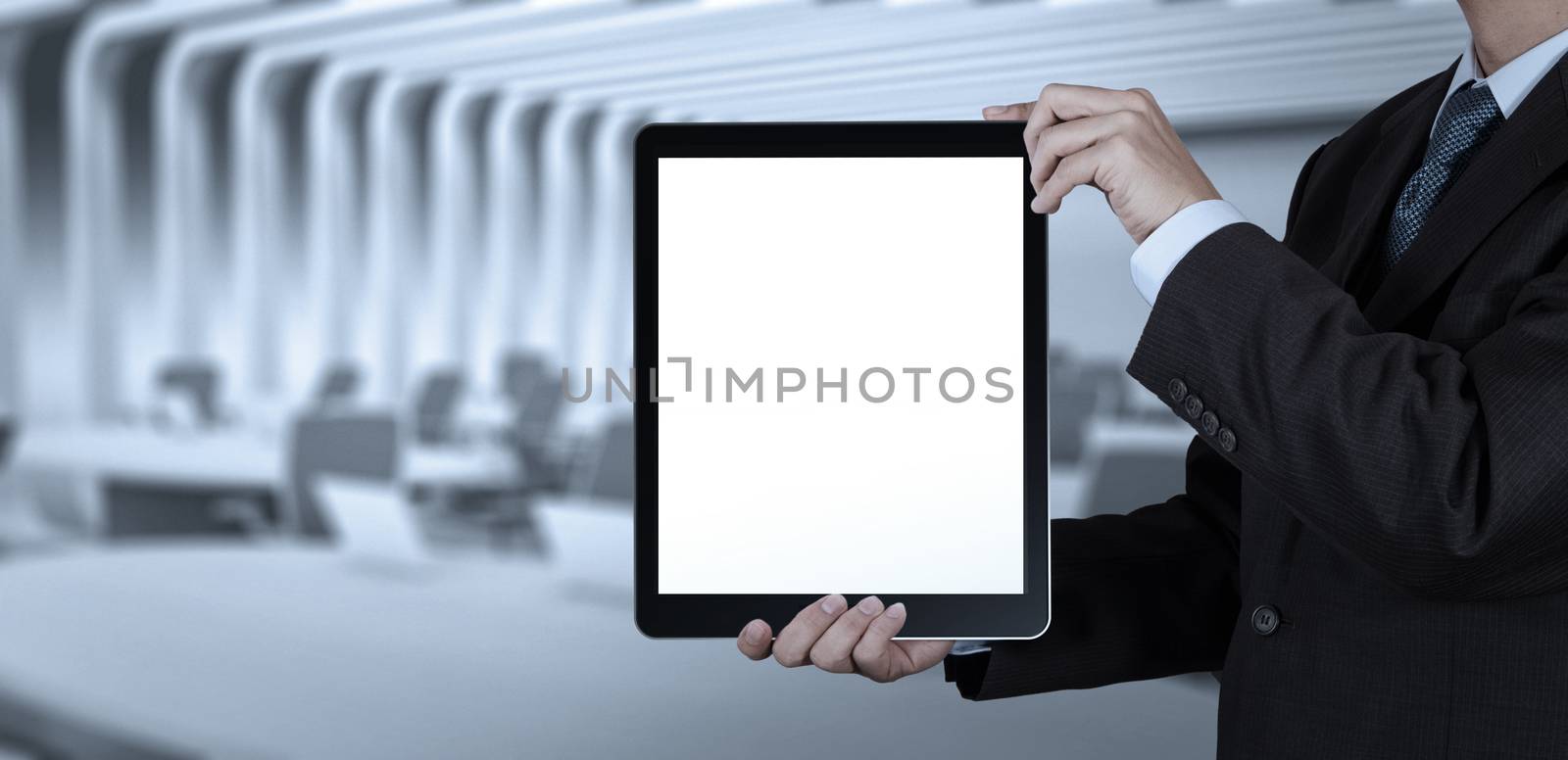 businessman success working with blank tablet computer his board room background