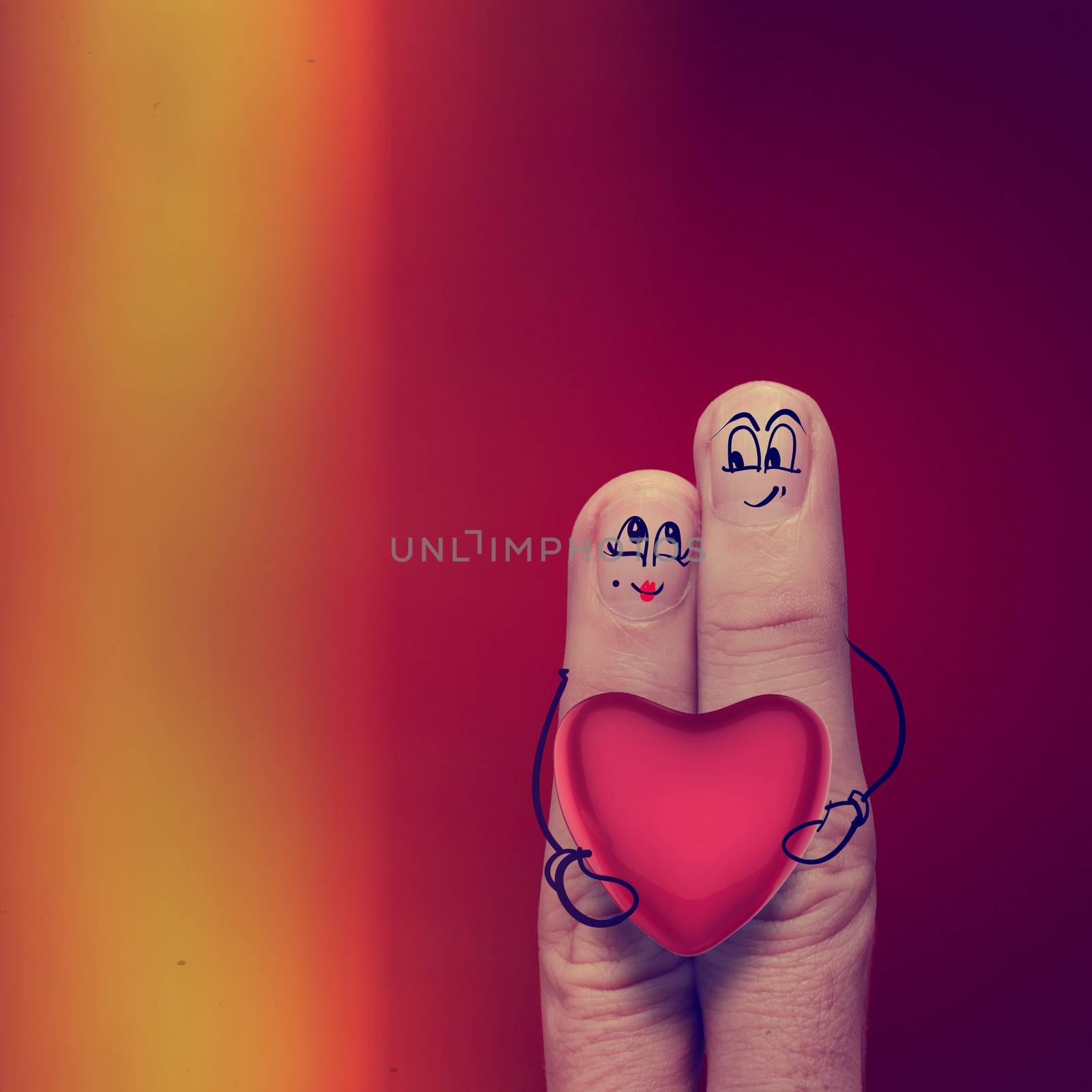 the happy finger couple in love with painted smiley and hold heart as vintage style