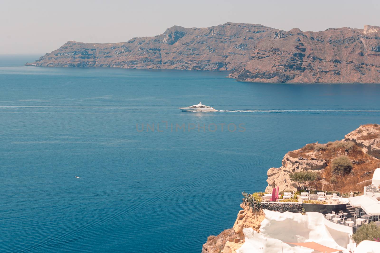 View on the seaside of Santorini island with ship on the sea