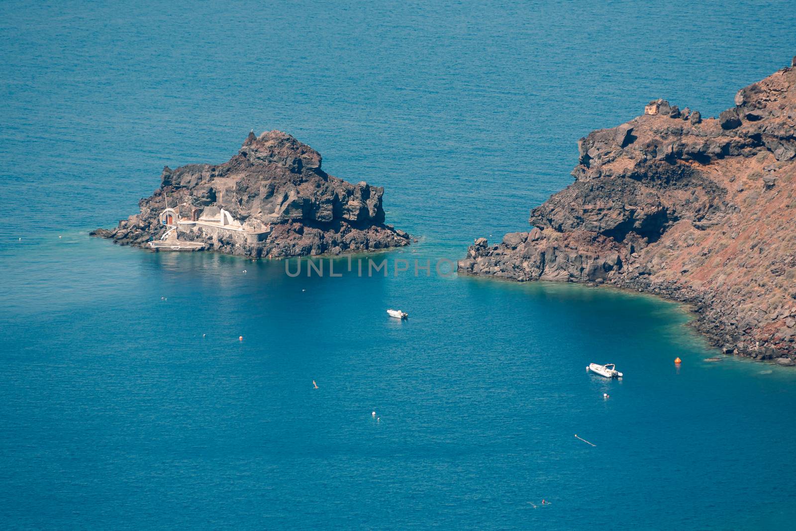 View on the seaside of Santorini island with ship on the sea by VIIIPhoto