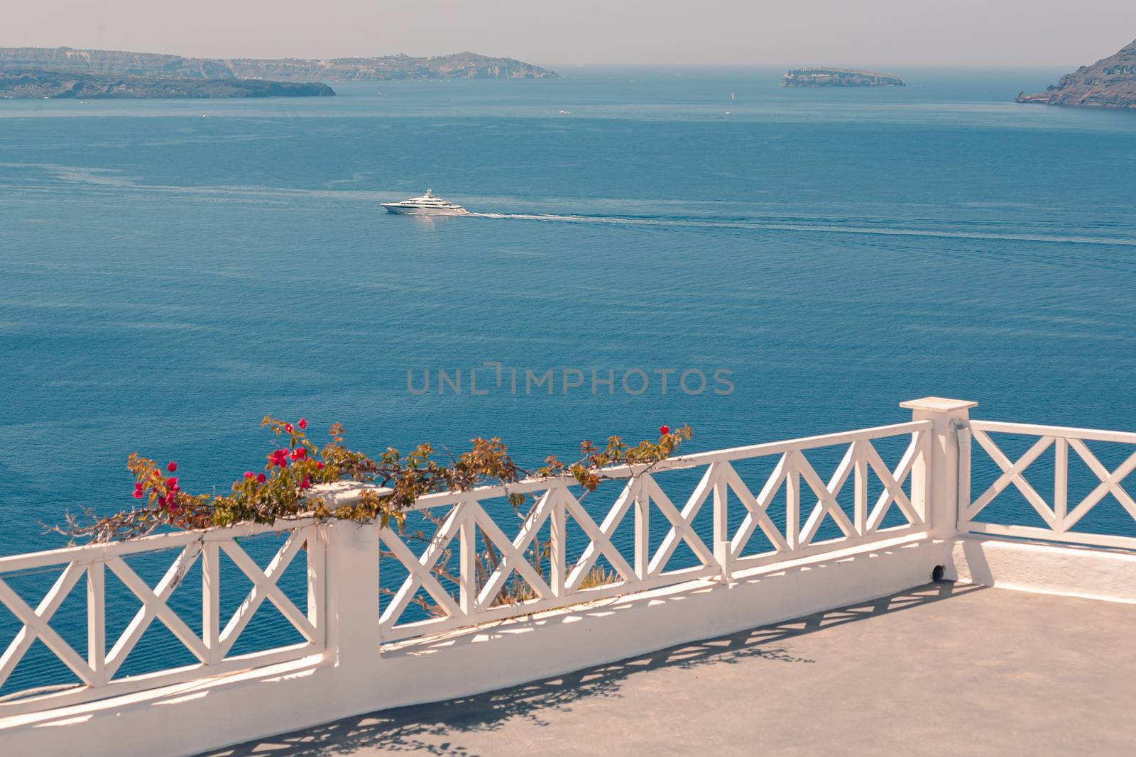 View on the seaside of Santorini island with ship on the sea by VIIIPhoto