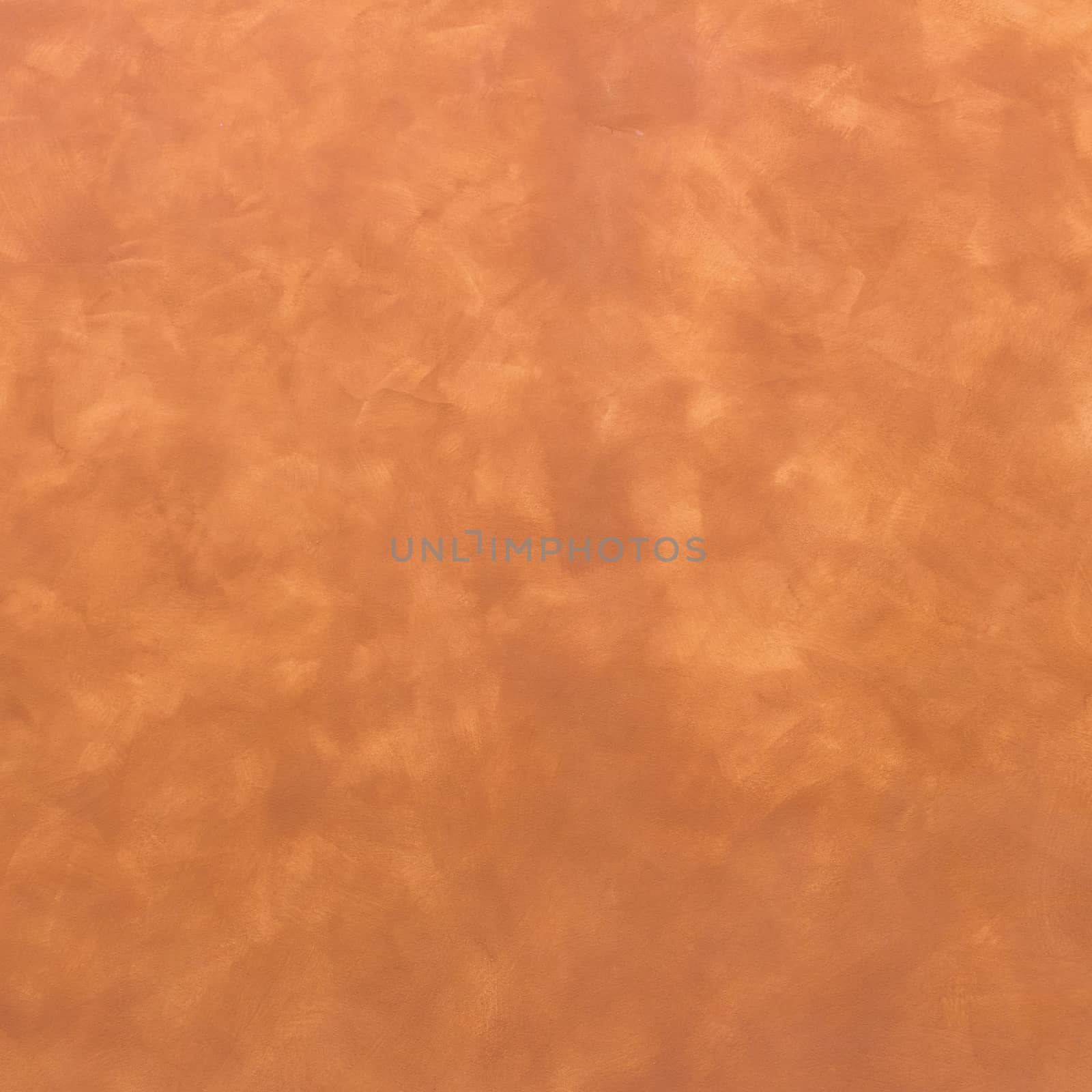 Background of a warm brown wall with rough plaster texture