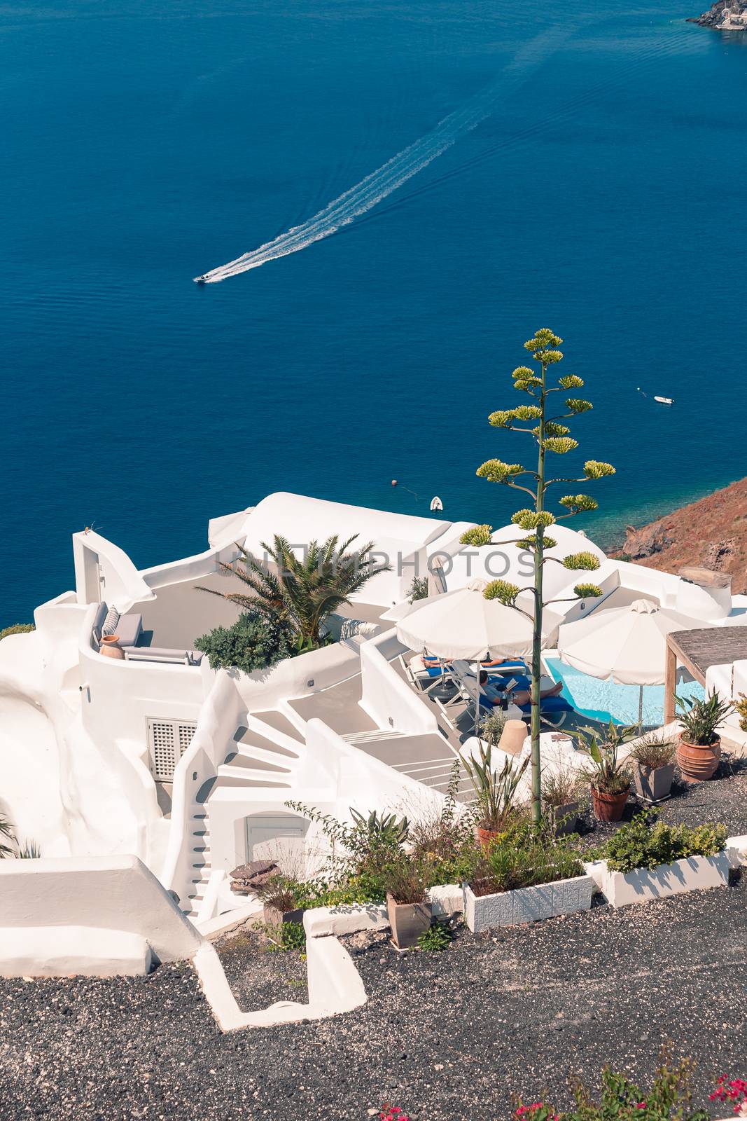 View on the seaside of Santorini island with ship on the sea by VIIIPhoto