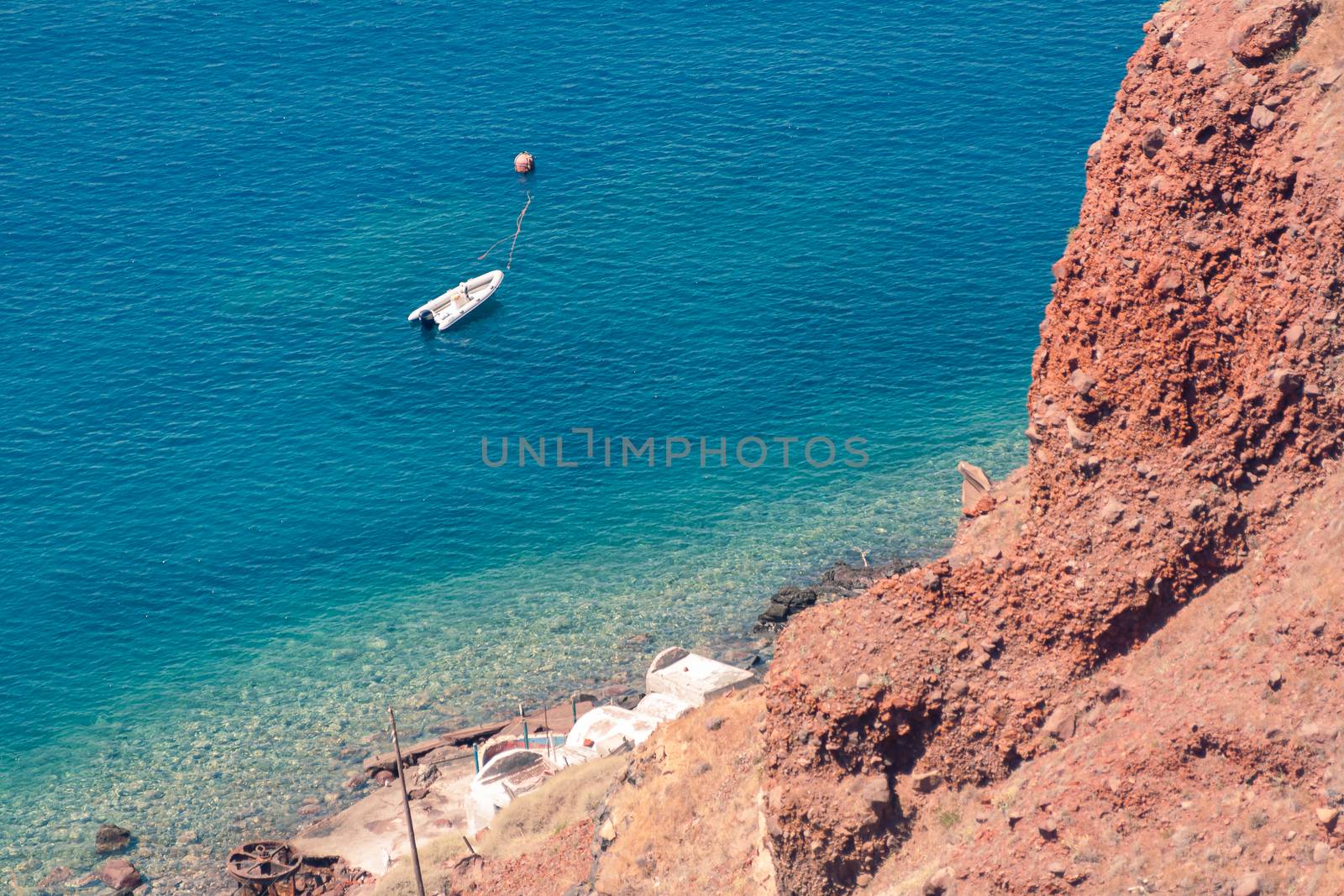 View on the seaside of Santorini island with ship on the sea by VIIIPhoto