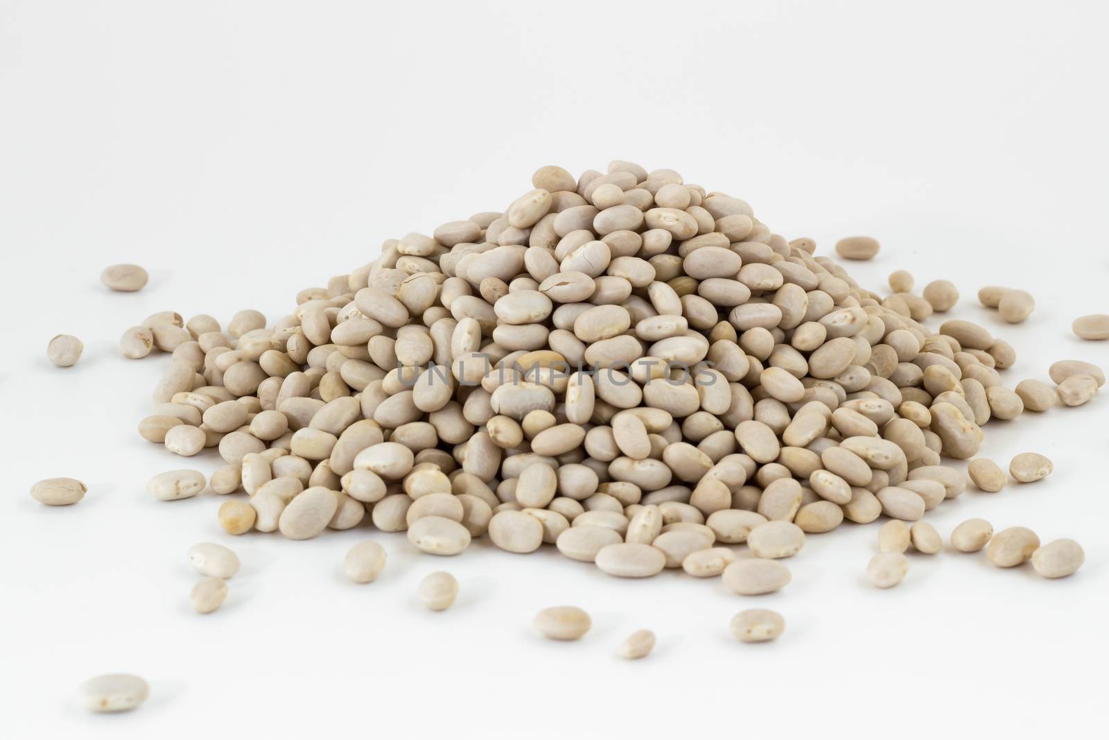Heap of navy beans on white background. Shallow DOF.