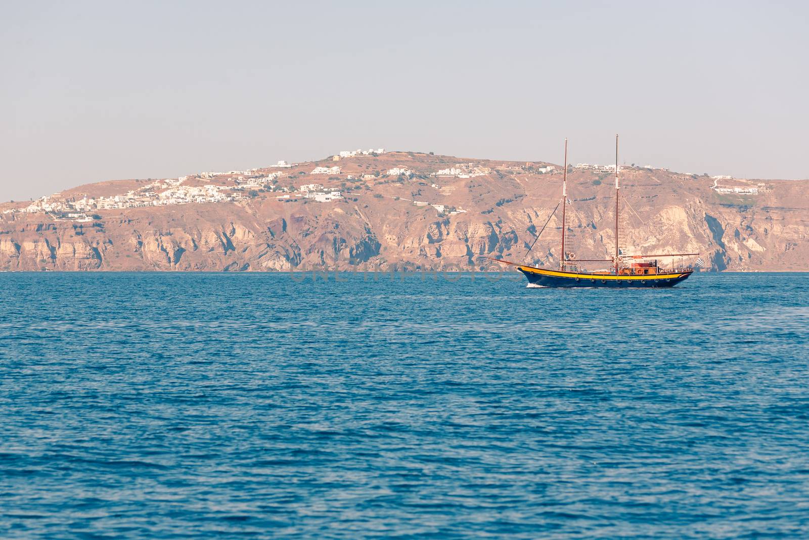 View on the seaside of Santorini island with ship on the sea