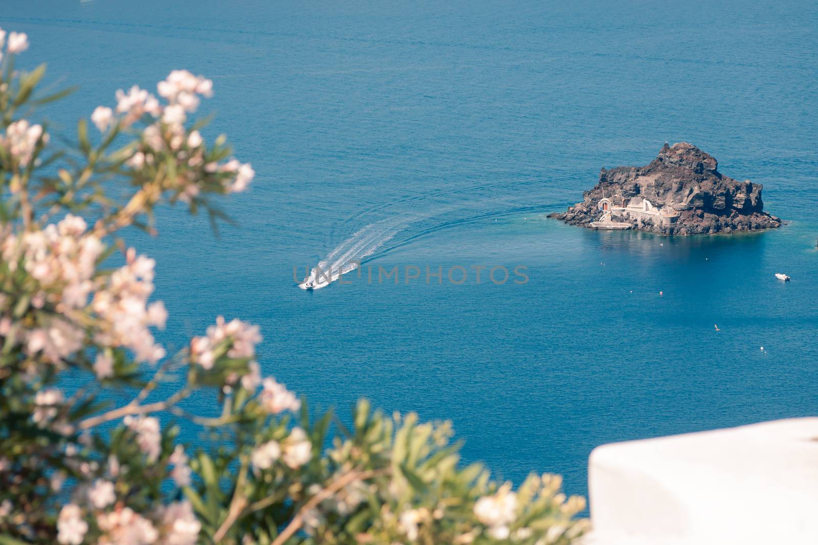 View on the seaside of Santorini island with ship on the sea by VIIIPhoto