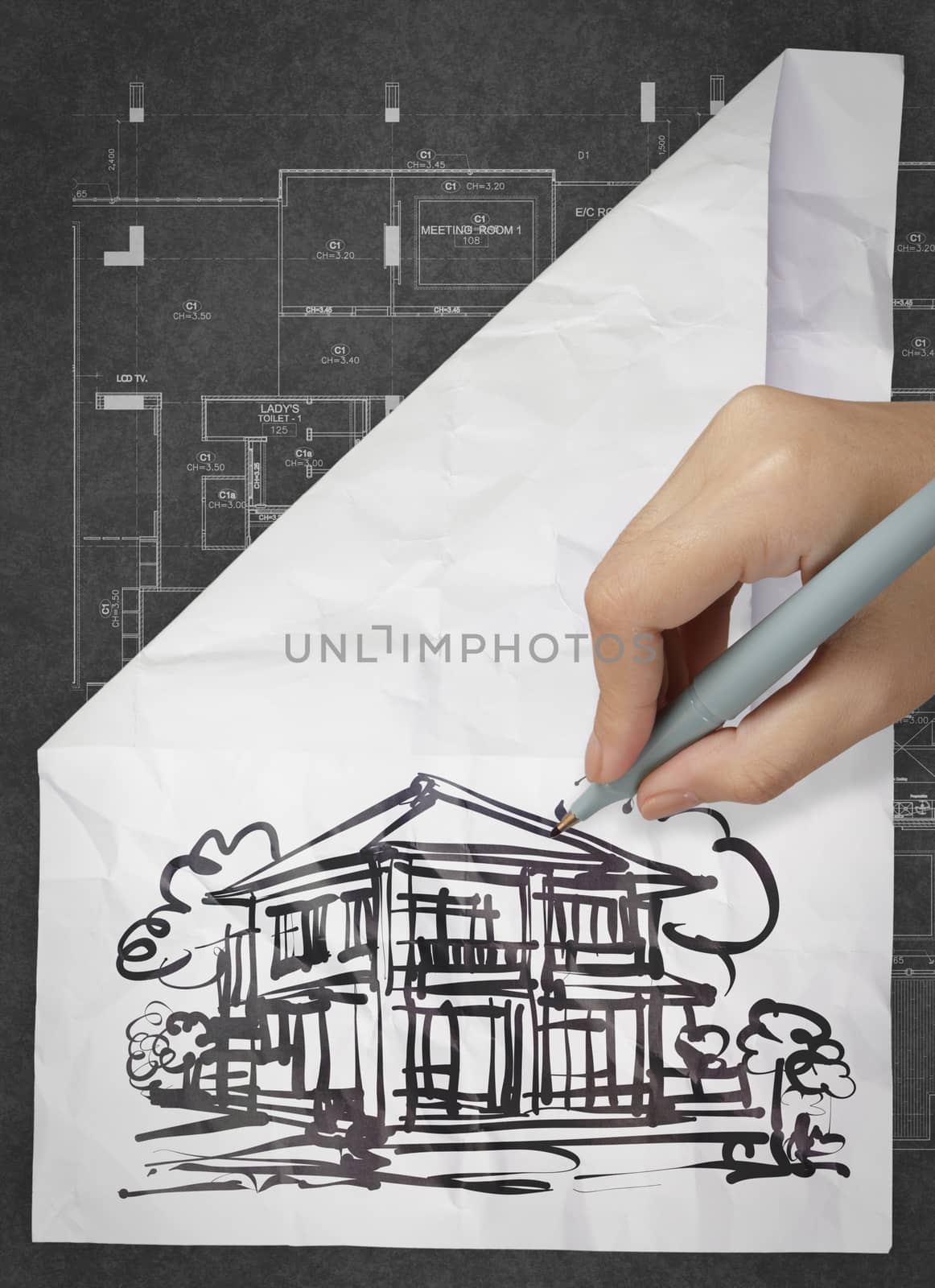 hand drawing house on wrinkled paper as concept