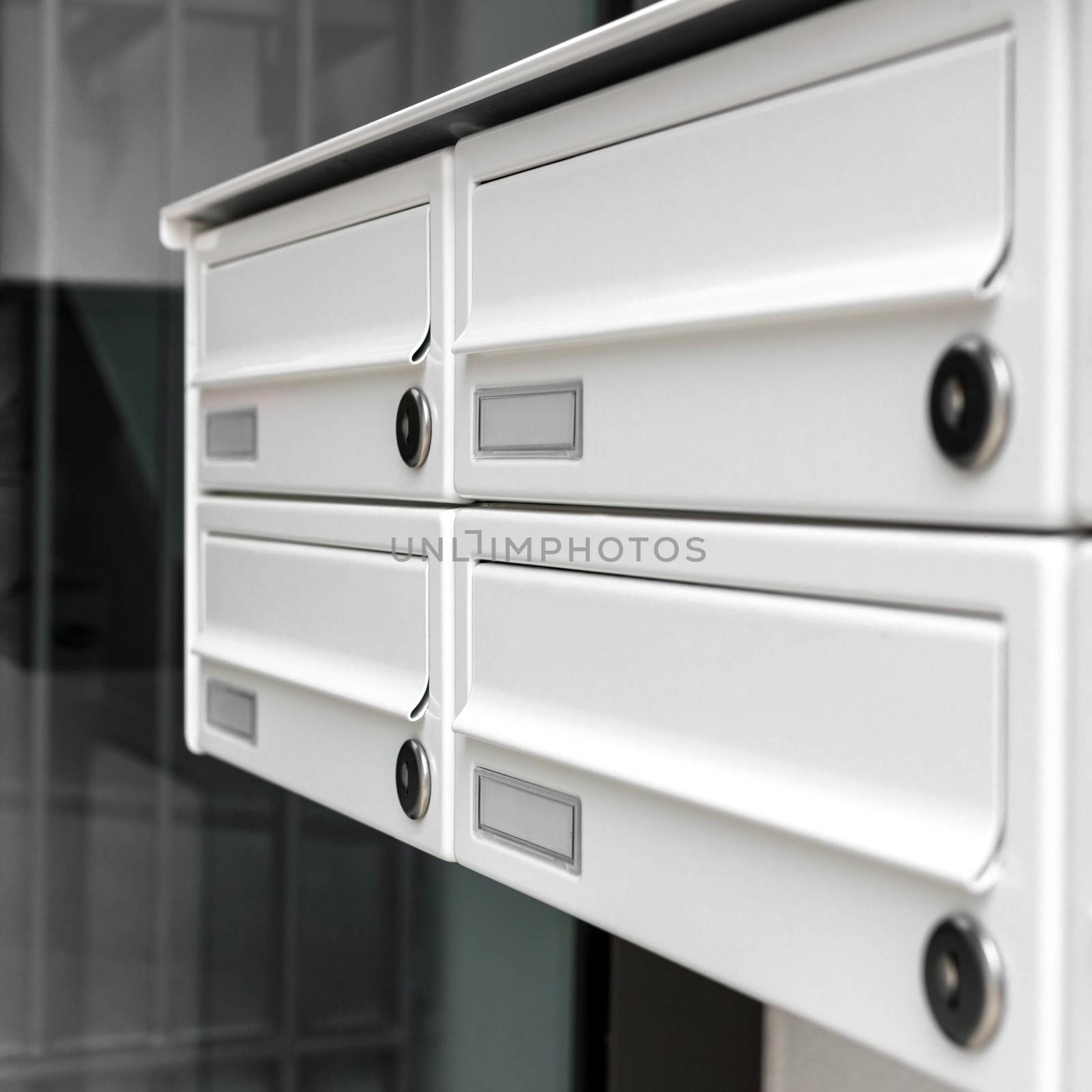 Four modern mailboxes of an apartment building (shallow DOF).