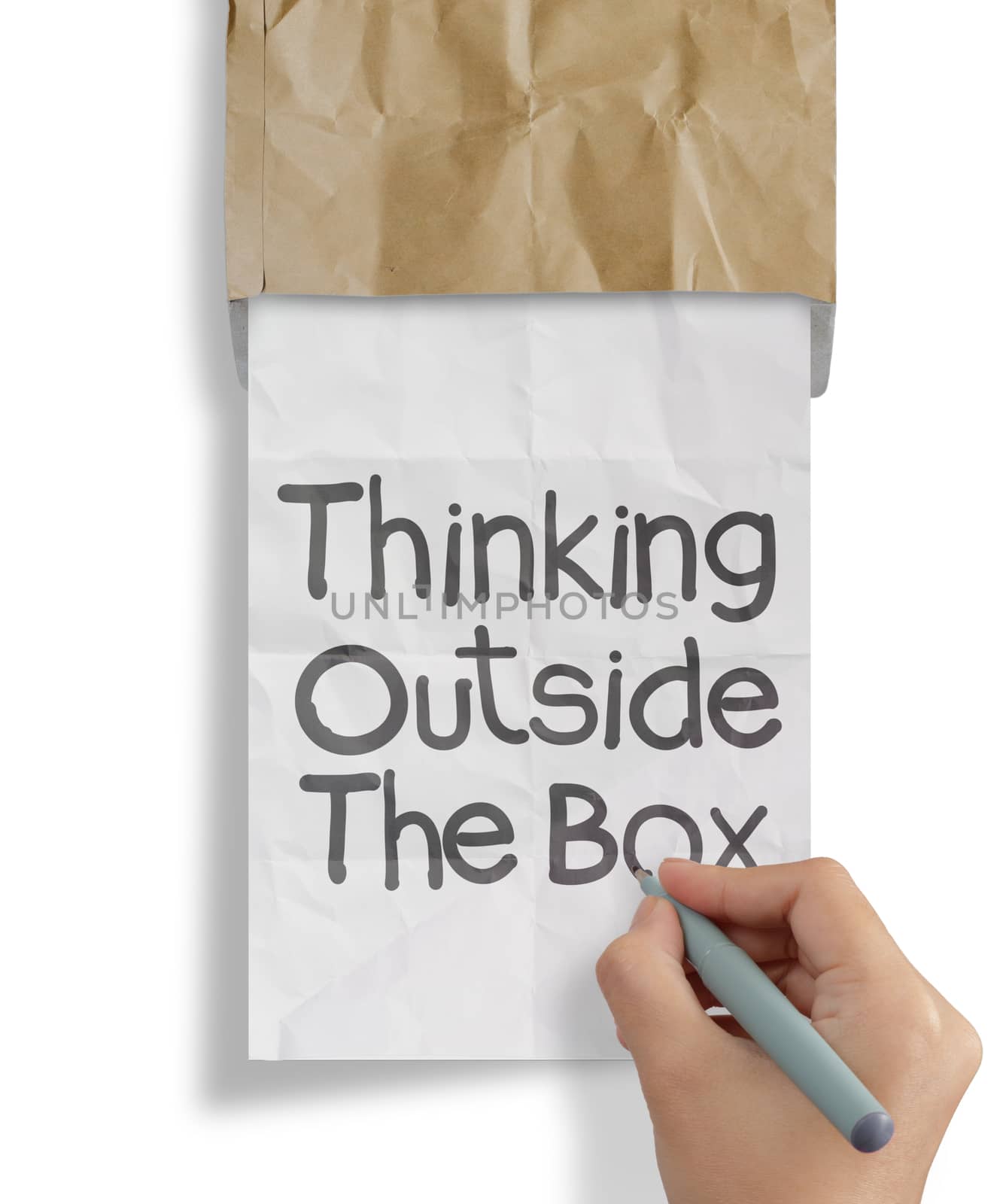 hand draws thinking outside te box on crumpled paper as concept