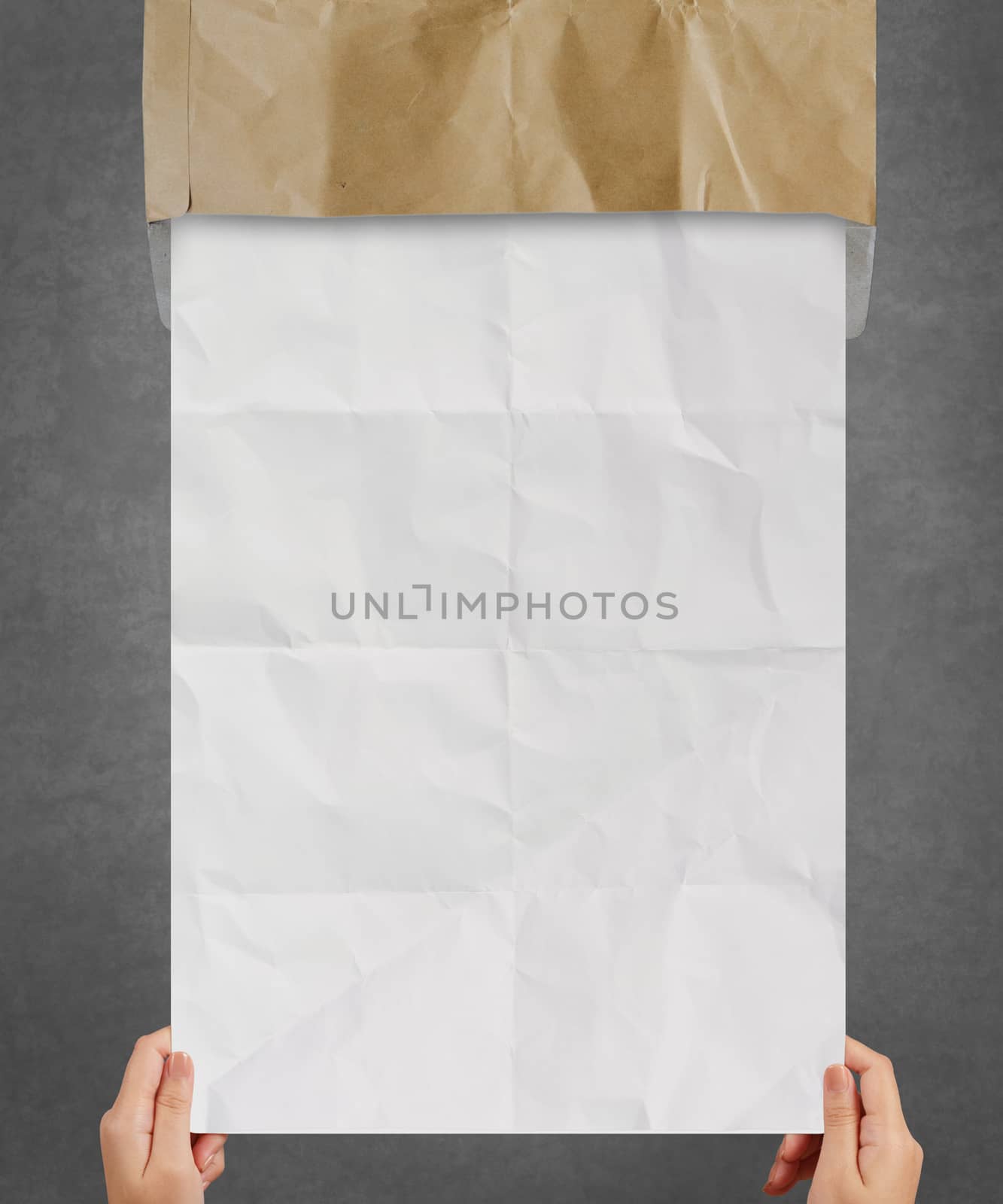 hand pulling crumpled paper from recycle envelope  by everythingpossible