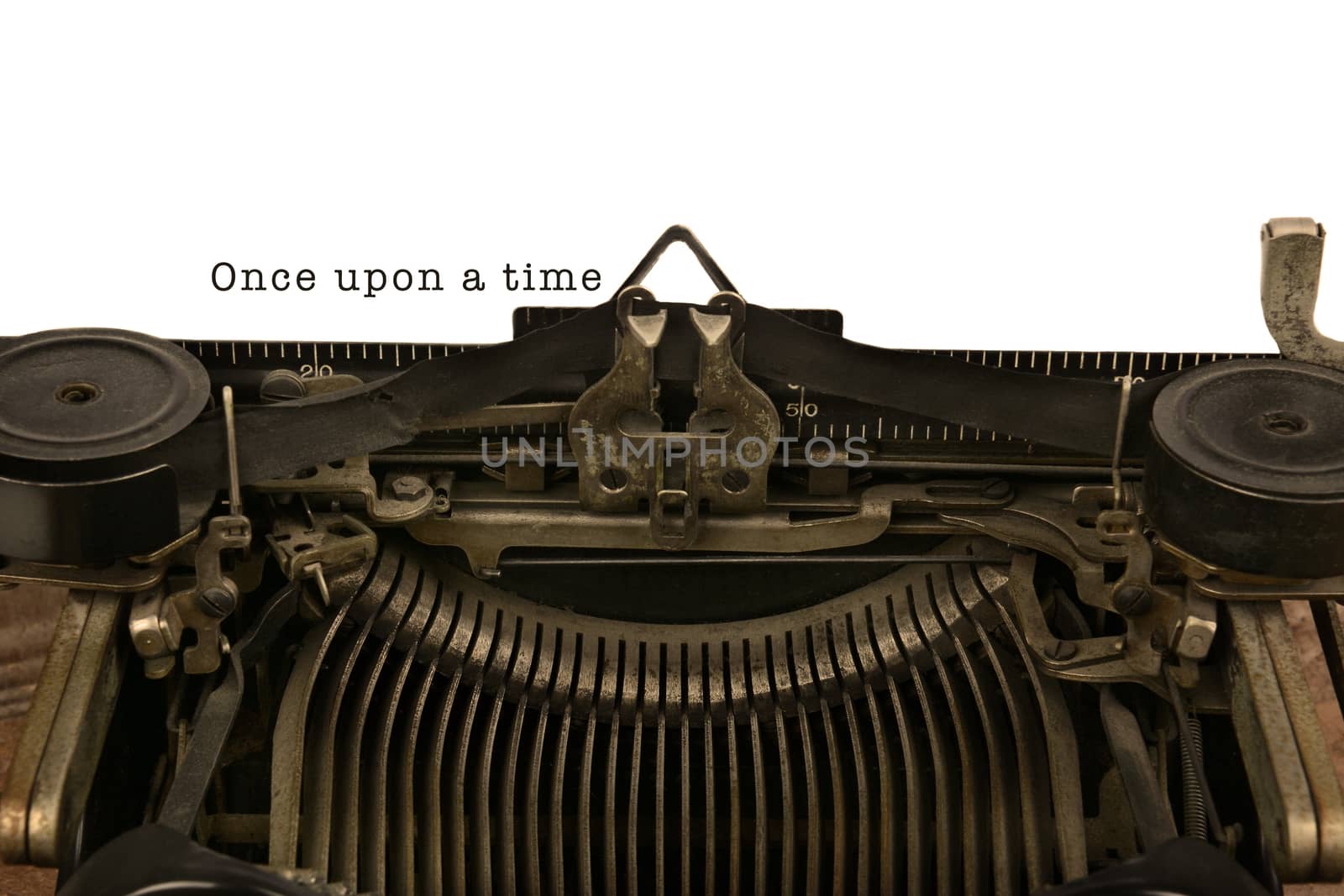 An old fashioned typewriter with the words Once upon a time. Closeup of the antique machines ribbon and carriage. With warm vintage tones.
