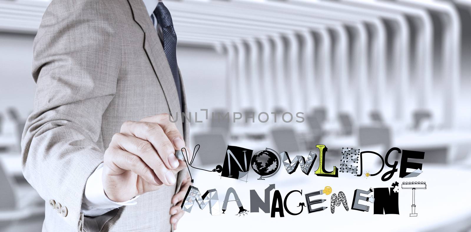 businessman hand drawing design word KNOWLEDGE MANAGEMENT as concept