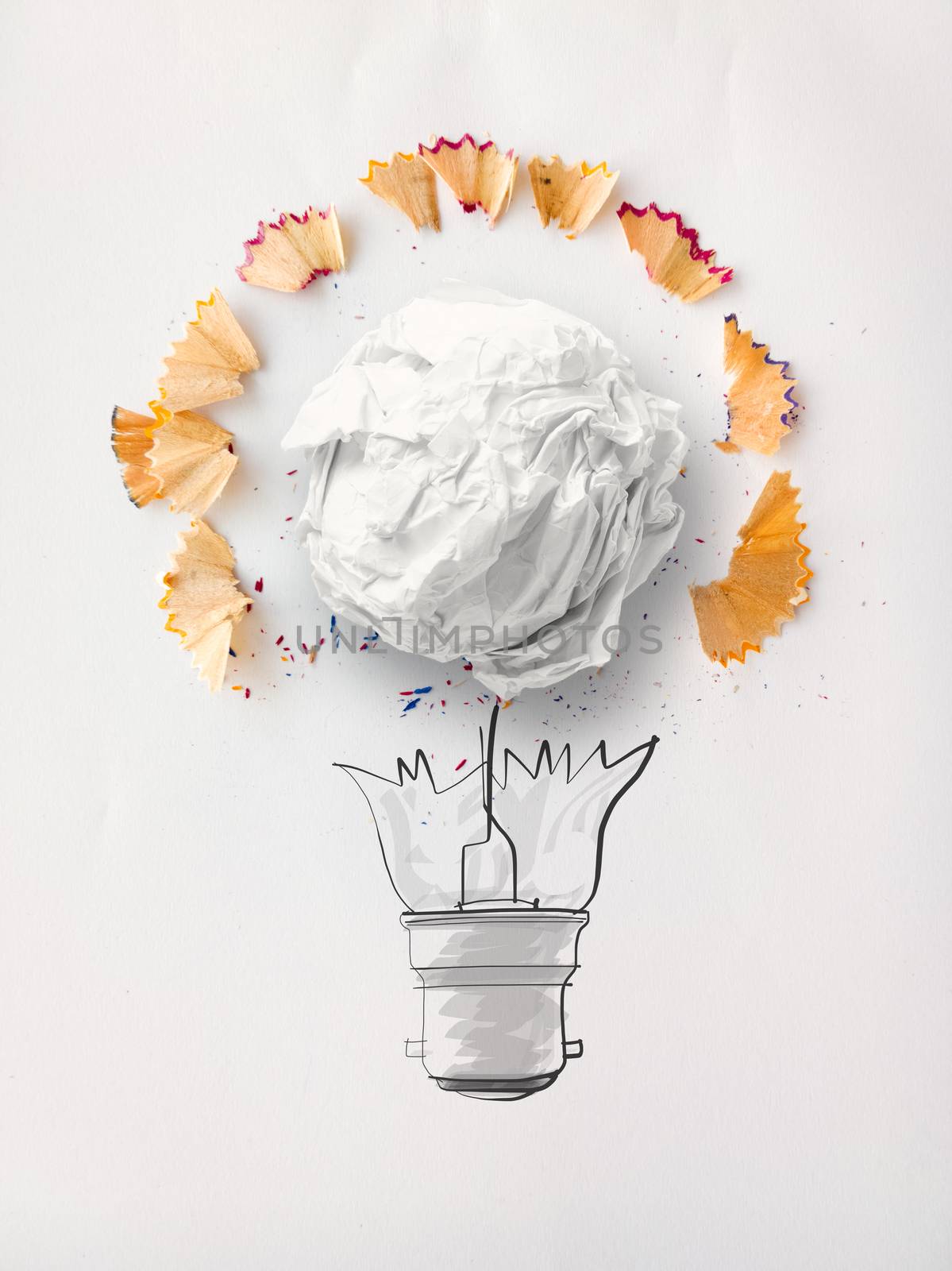 hand drawn light bulb and crumpled paper with pencil saw dust on paper background as creative concept