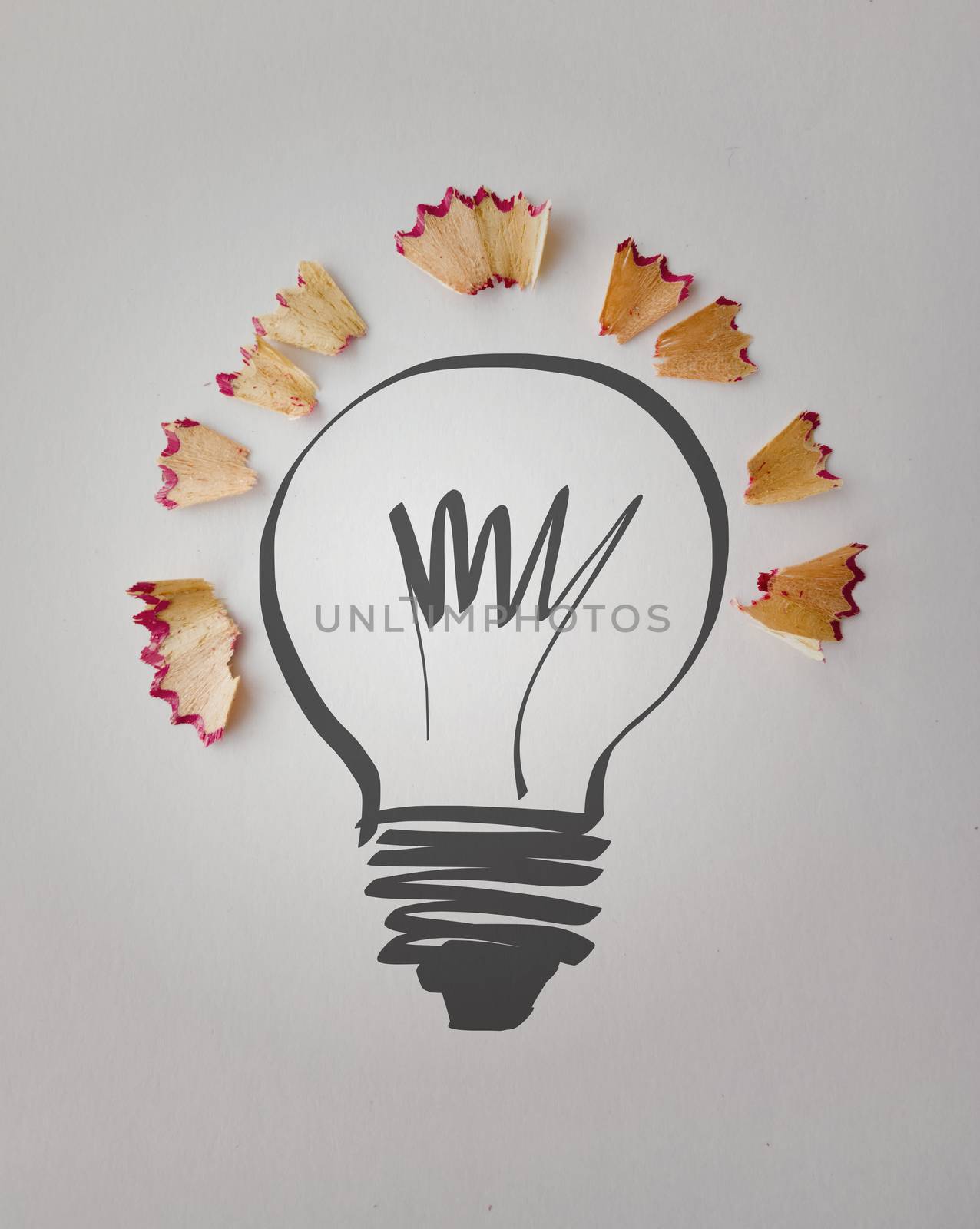 hand drawn light bulb with pencil saw dust on paper background as creative concept