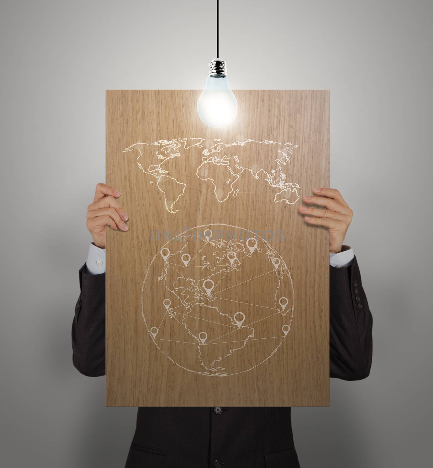 man showing poster of hand drawn world social network diagram on wooden board with growing lightbulb as concept 