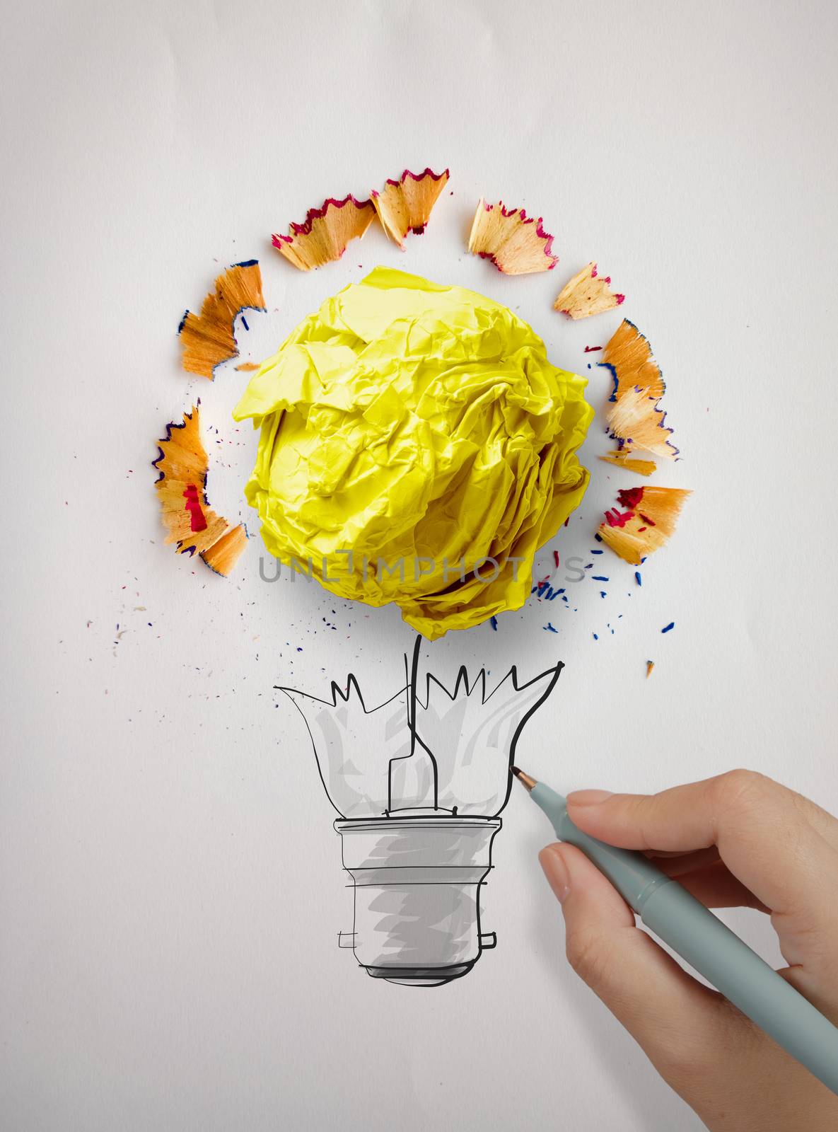 hand drawing  light bulb and crumpled paper with pencil saw dust on paper background as creative concept