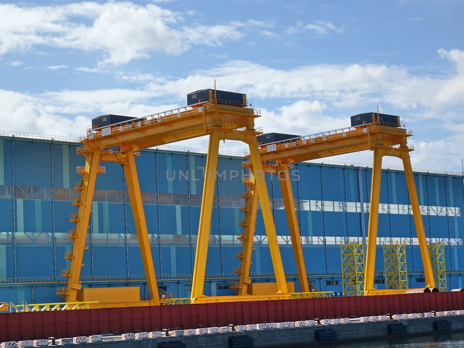 Two large gantry cranes. The Chinese writing says, Safety First.