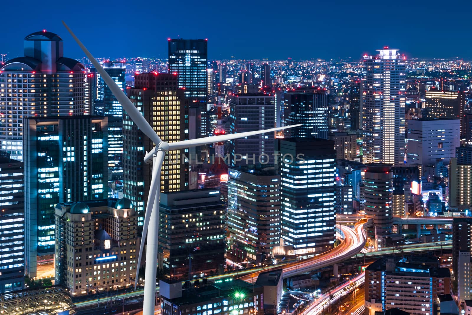 Wind turbine power on the cityscape background